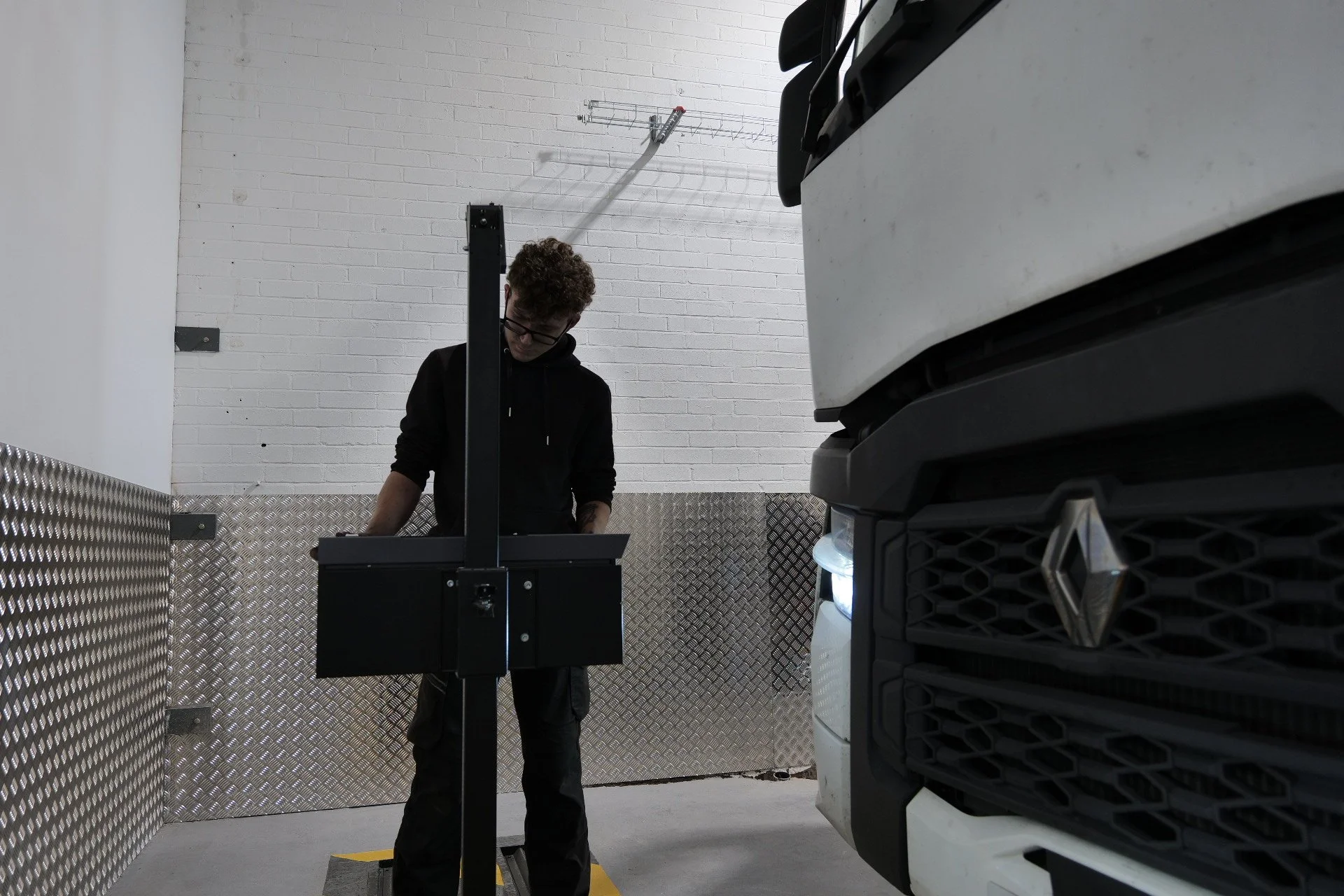 A vintage bus in a parking lot with a white body and orange accents, with the words 'Jackland & Berkeley' printed on the side.