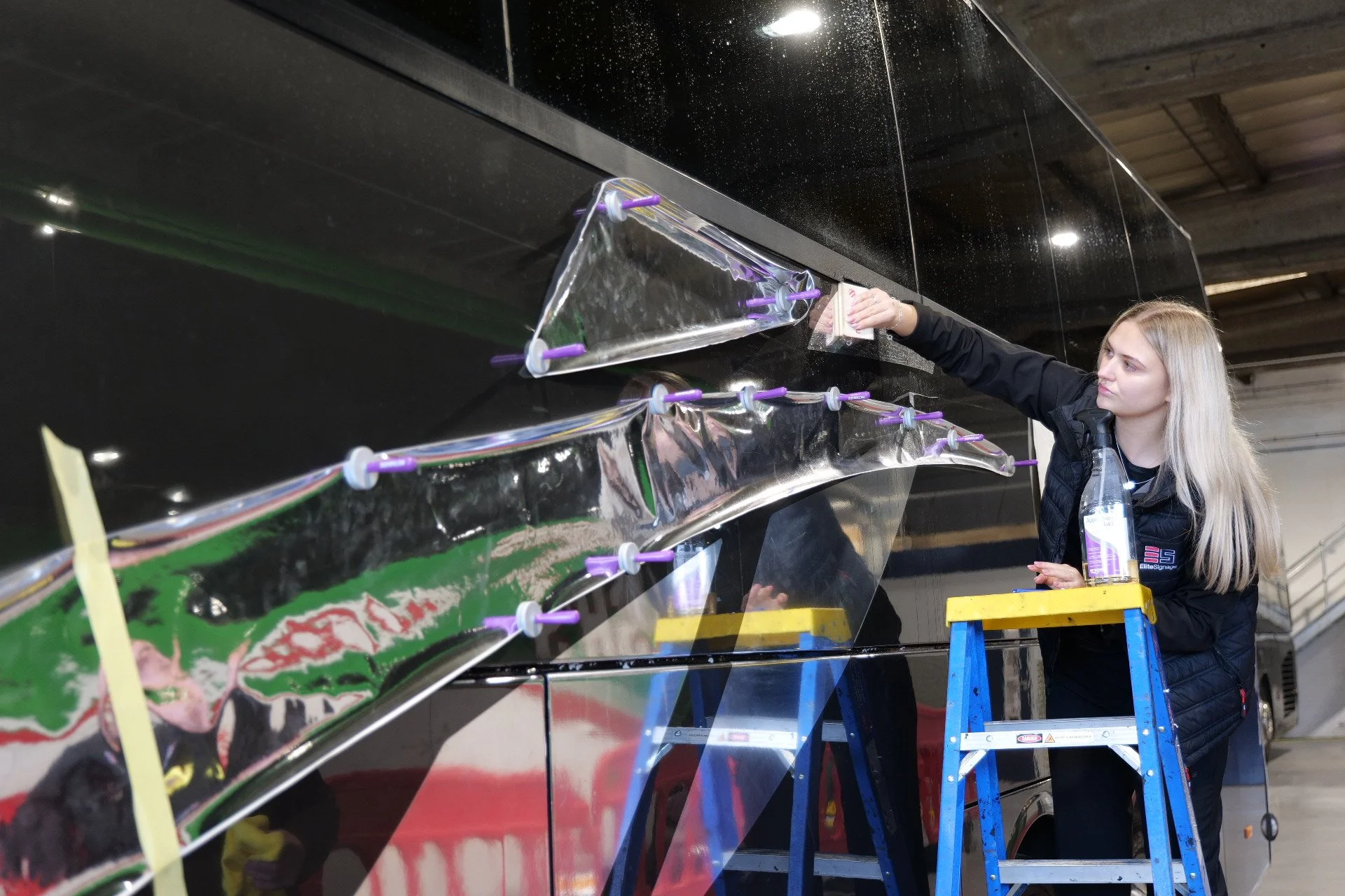 A yellow Ellie Rose of Hull tour bus parked on wet pavement under a partly cloudy sky.