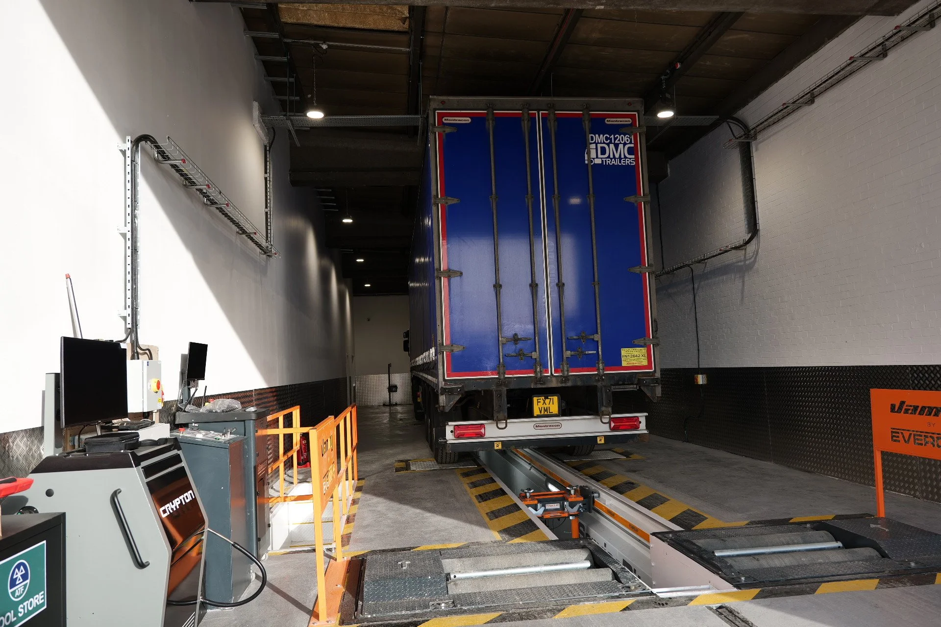 Large black double-decker coach with the name 'ACKLAMS' on the side, parked in a lot.