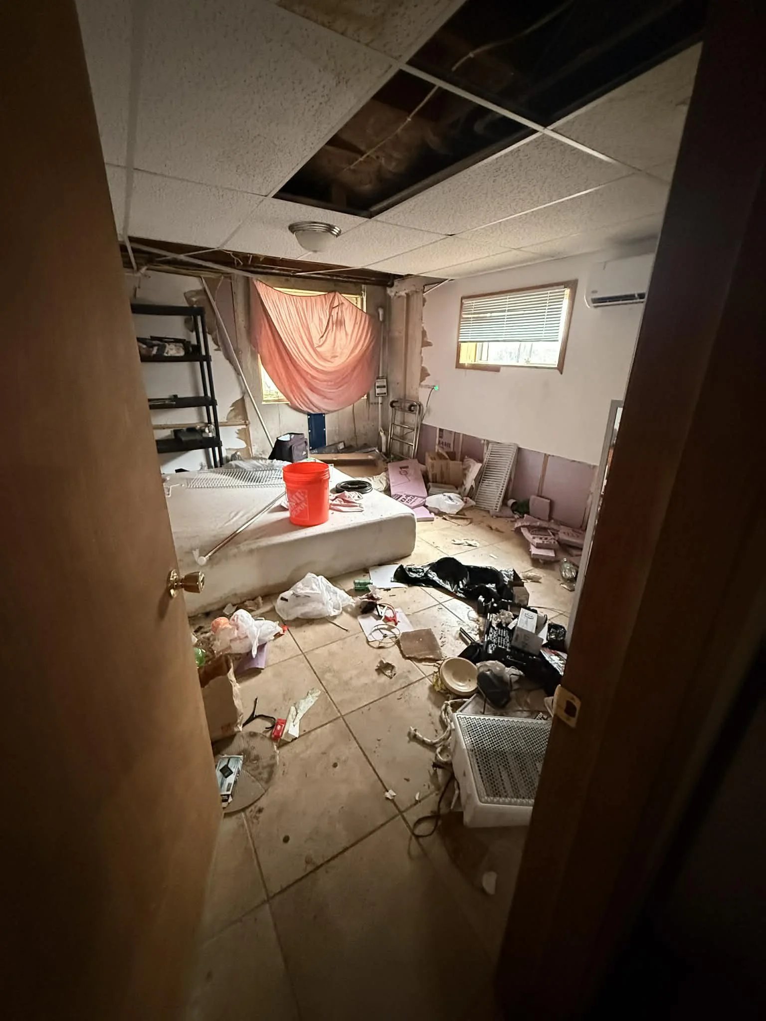 Interior cleanout in progress showing removal of debris, materials, and unwanted items from a residential space.