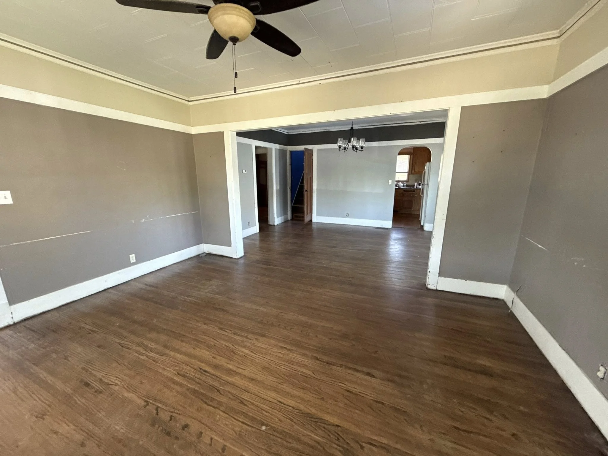 Empty living room after junk removal and cleanout, featuring hardwood floors and open layout