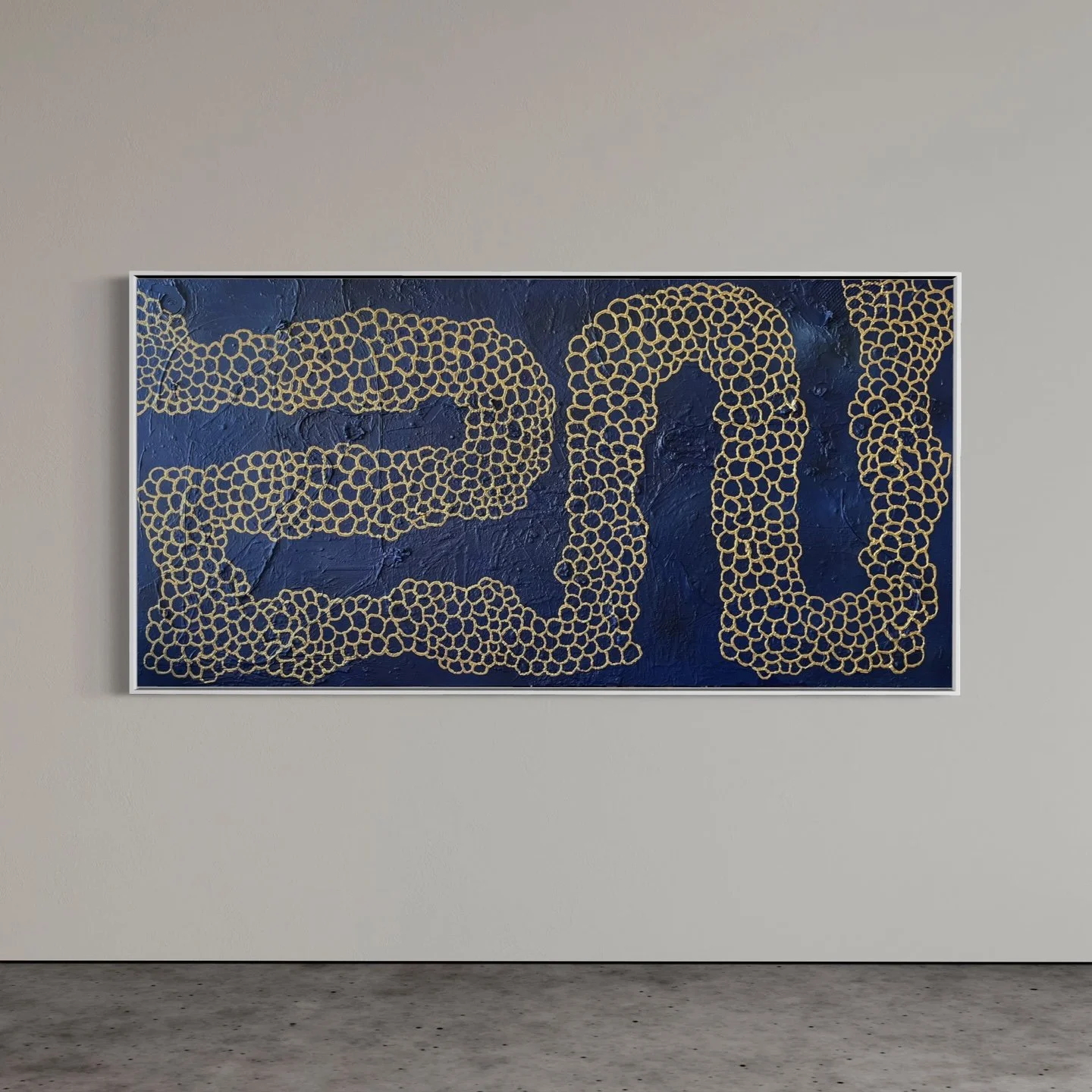 Artwork with the number 20 made of small gold circles on a textured dark blue background, framed on a white wall.