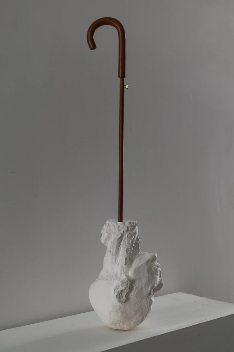 2021 Umbrella Man, plaster cast and wood, 40 x 10"