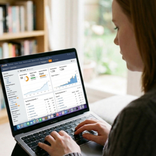 Hannah oneill sitting at laptop performing a marketing audit