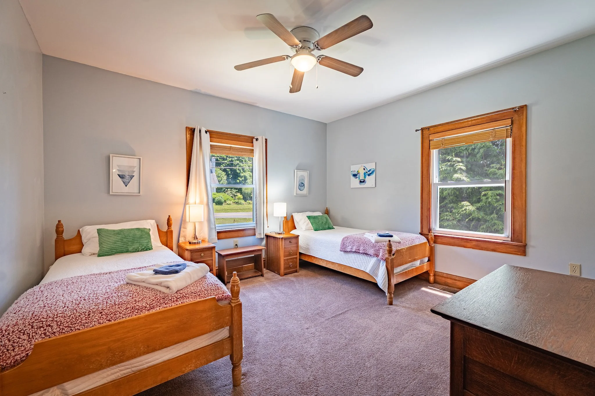 Bedroom at the pet-friendly cozy cottage  with two twin beds at New River Nooks in New River Gorge, WV.