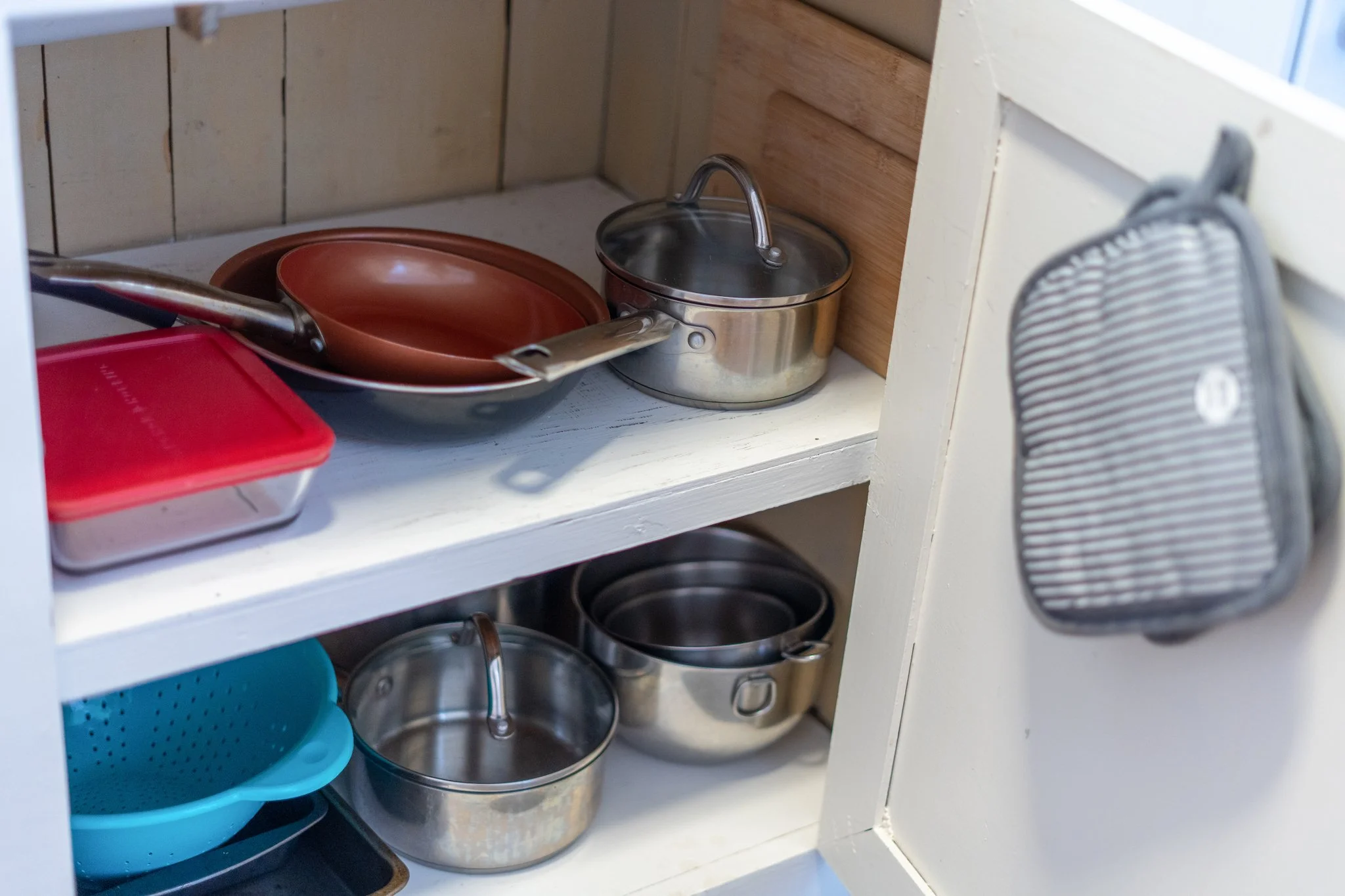 Cabinet containing pots and pans at Cloud 9 Loft Apartment in Fayetteville, WV.