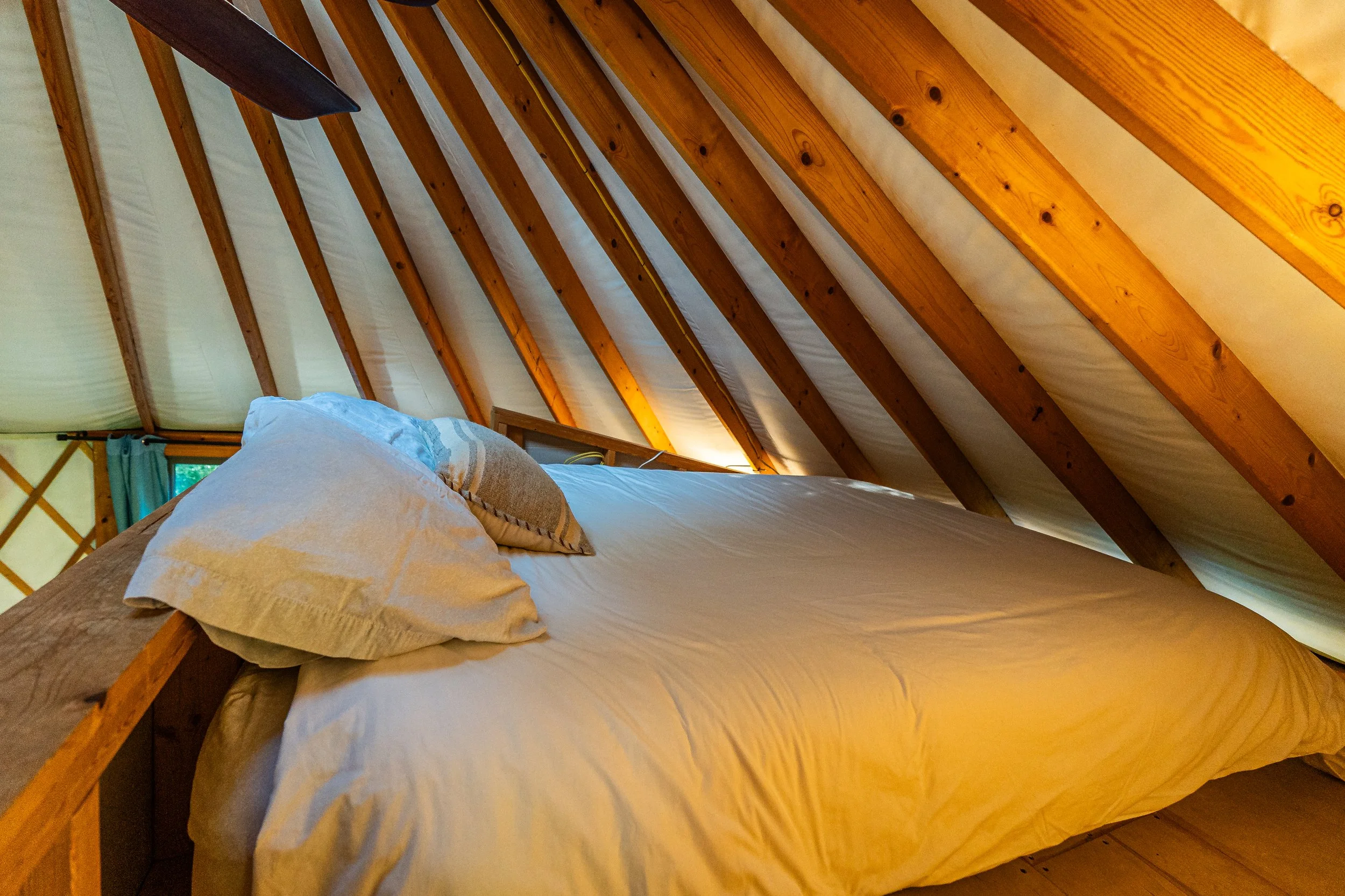 Loft queen bed in the cozy yurt in New River Gorge WV.