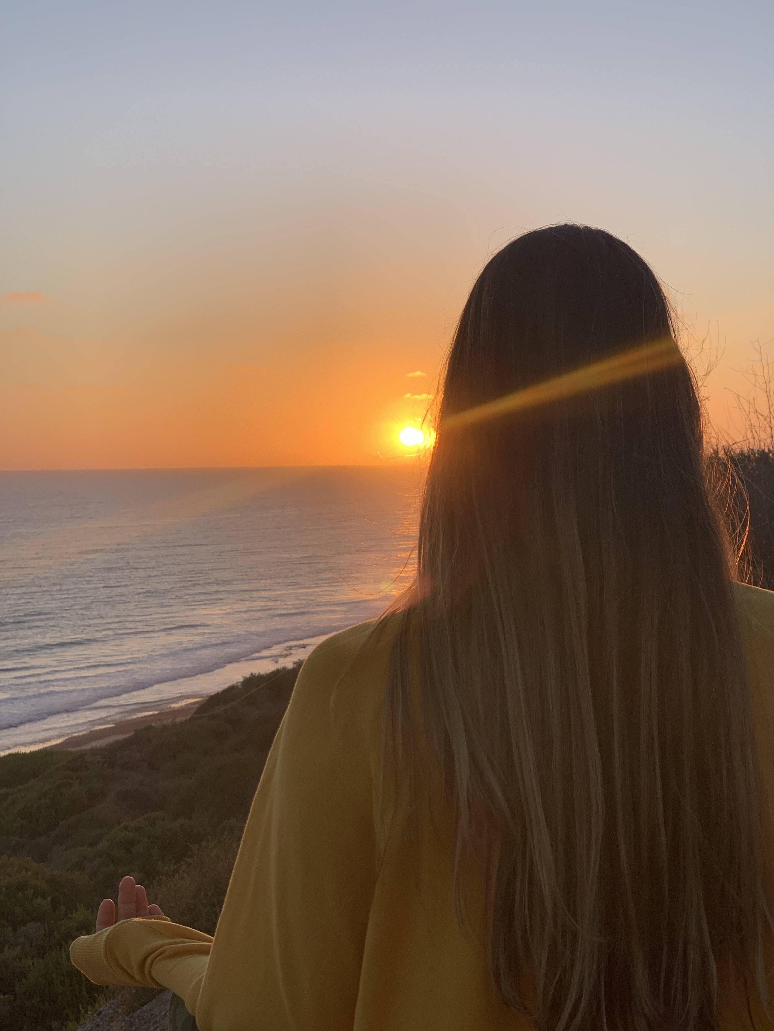 A woman sitting and meditating on the beach. She is calm and at peace. She is able to manage and cope with hardships in life. Individual counseling in Bryan Texas offers DBT Counseling.