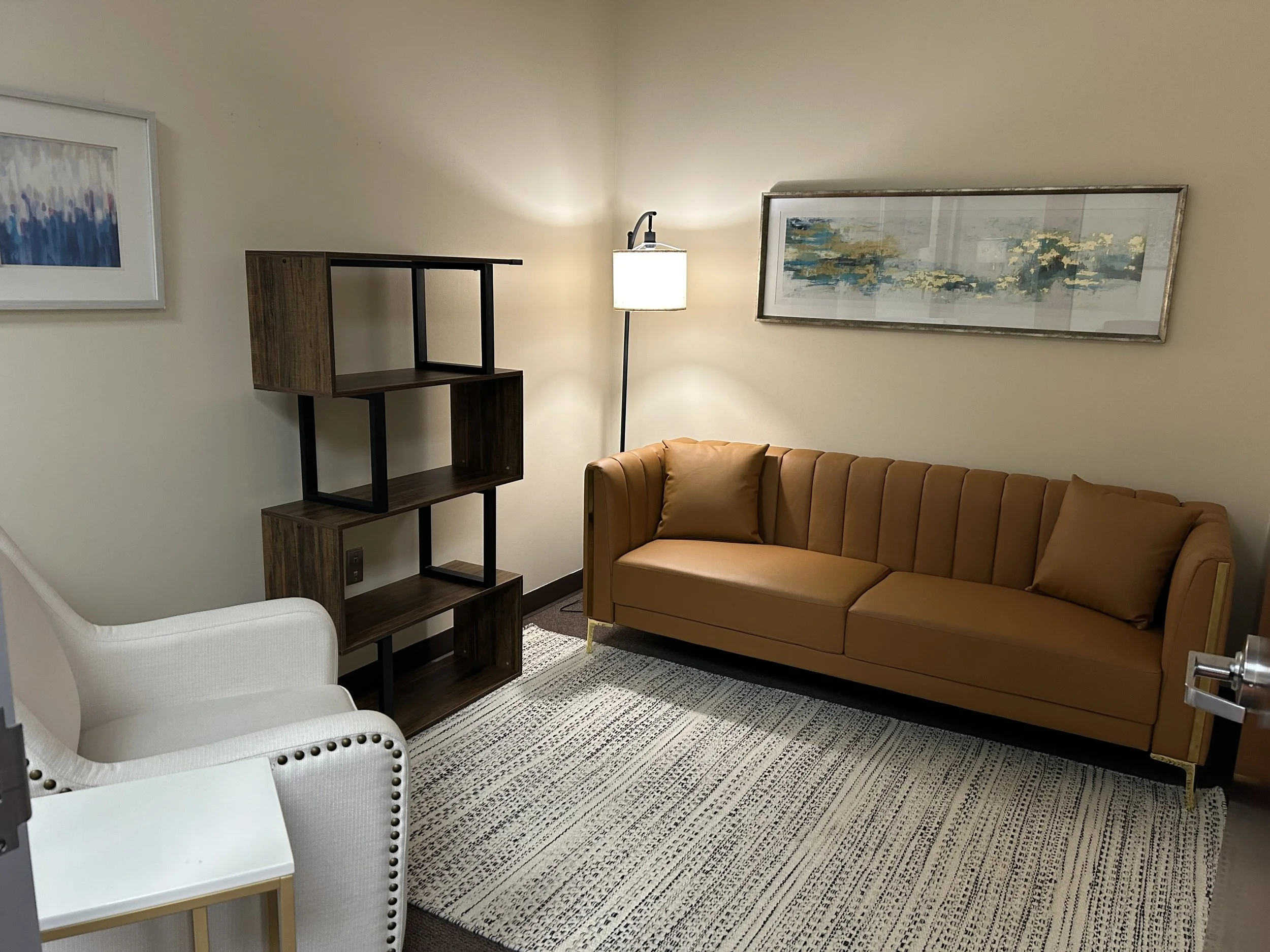 office with sofa, chair and bookshelf