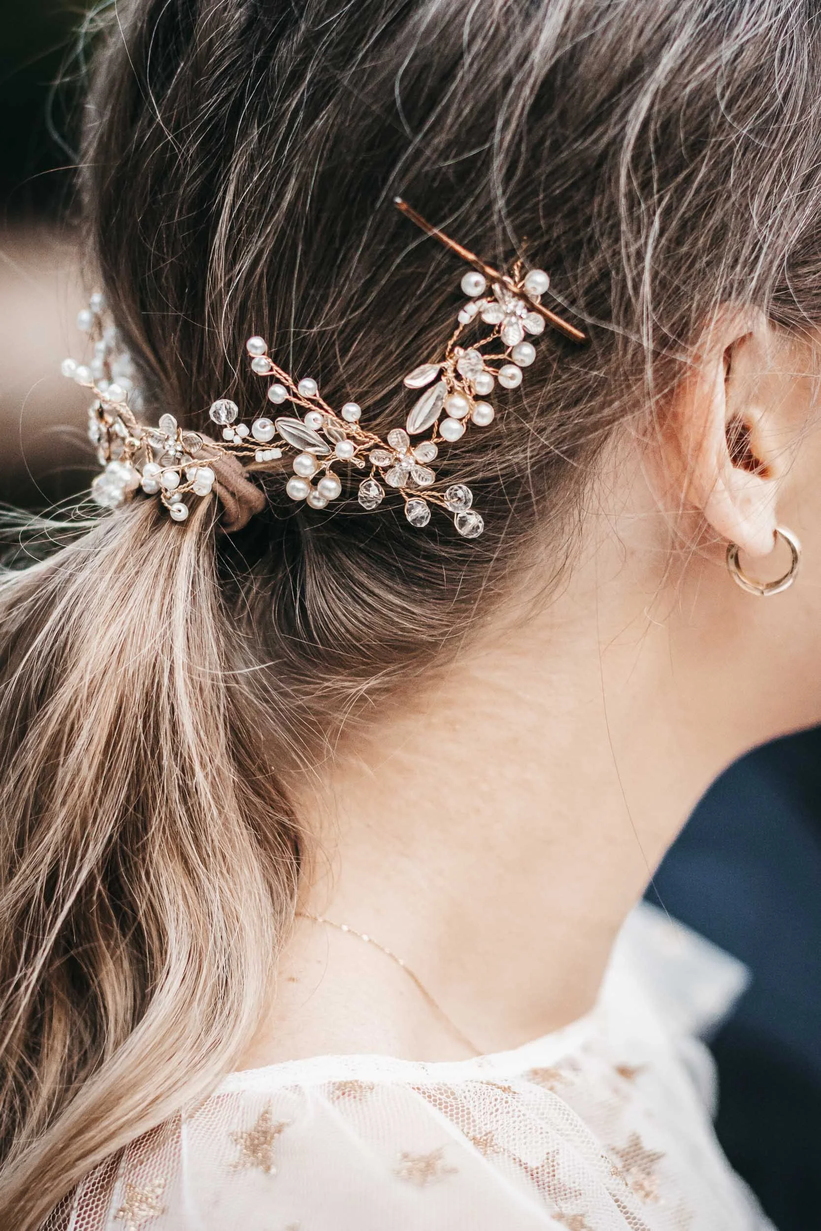 Close-up detail of the bride's hairstyle with a floral hair accessory