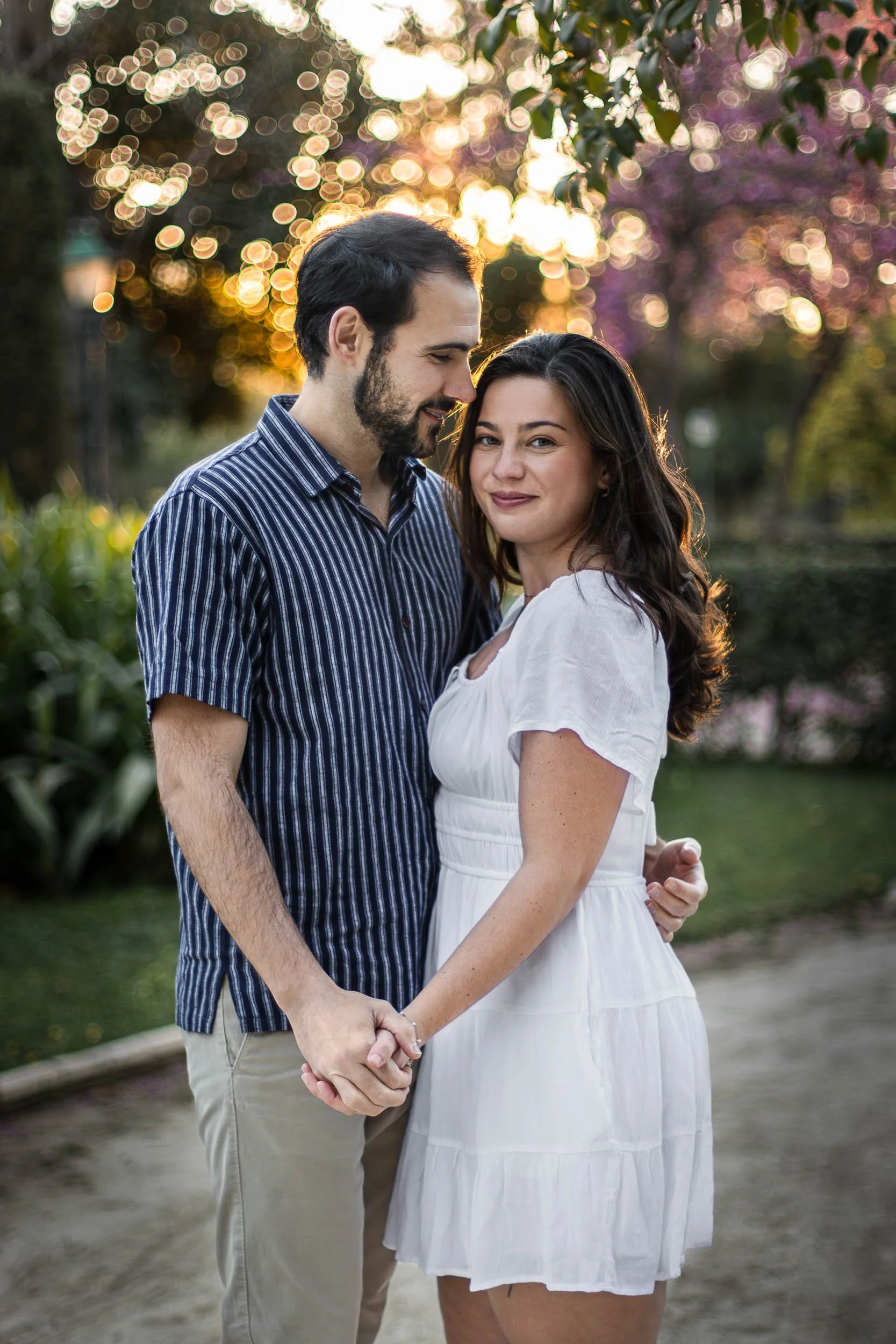 Portrait of a couple standing hand in hand during a golden-hour park session