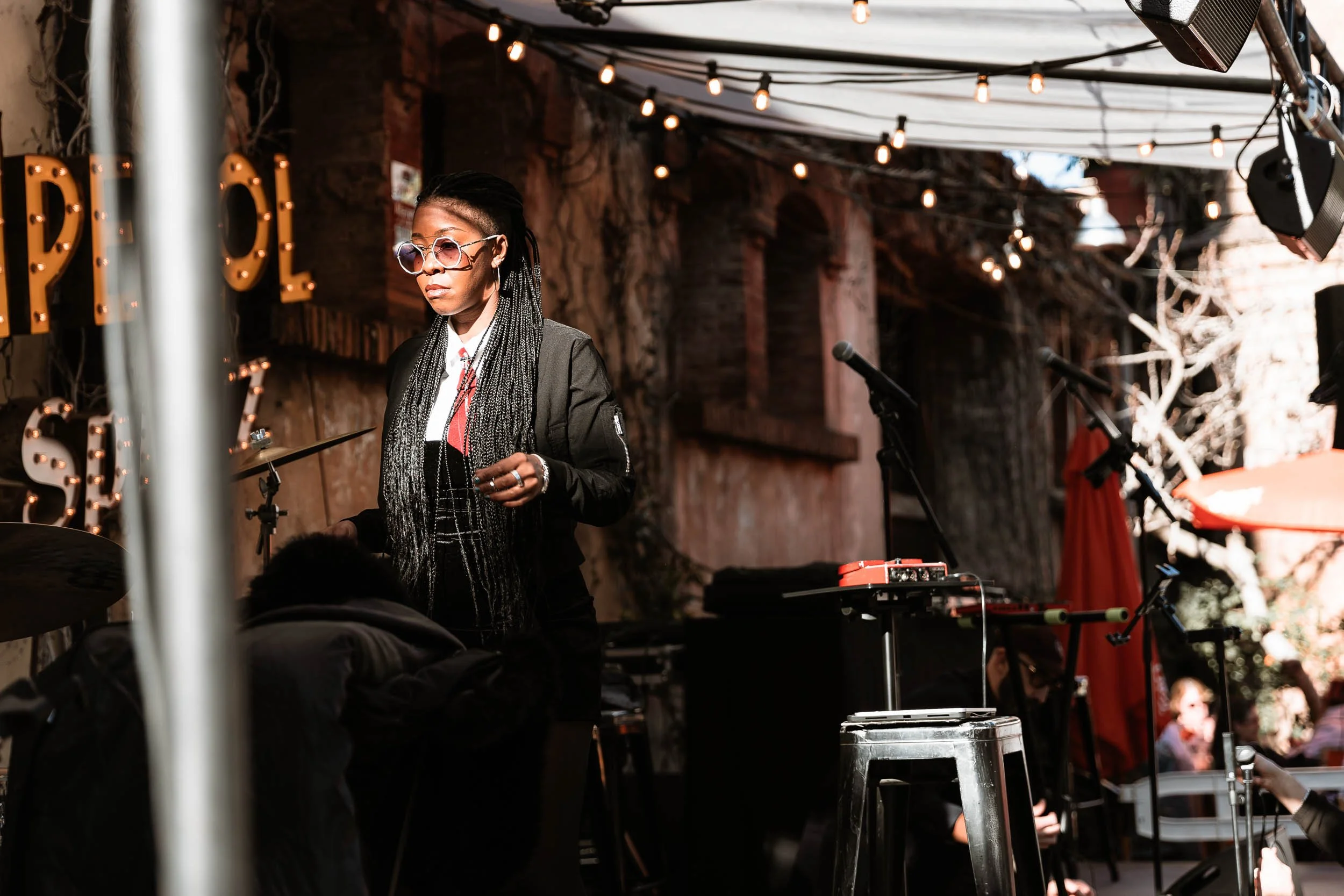 Preparation for a live music performance during an event in an outdoor industrial-style venue