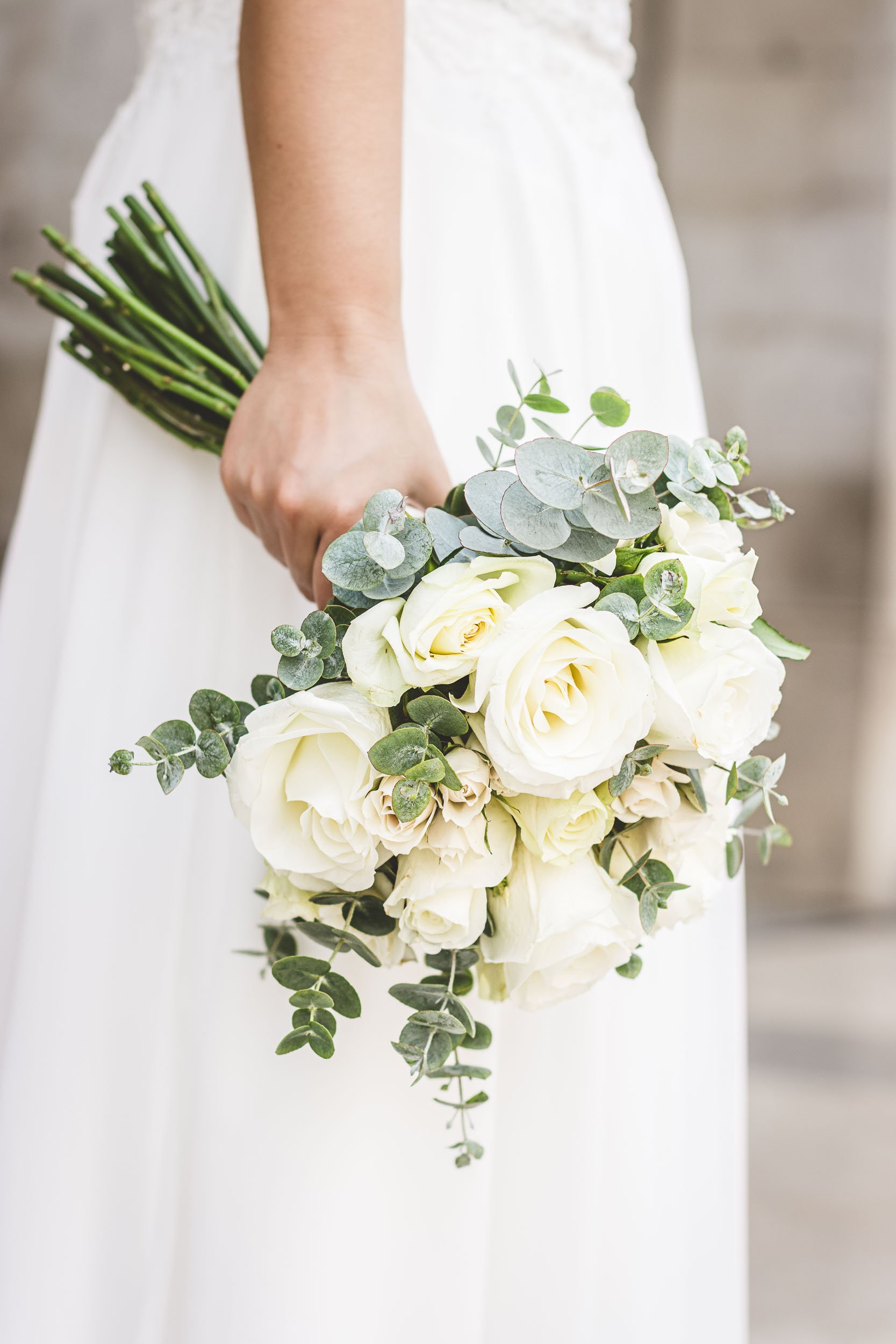 Close-up of the bride holding a white wedding bouquet