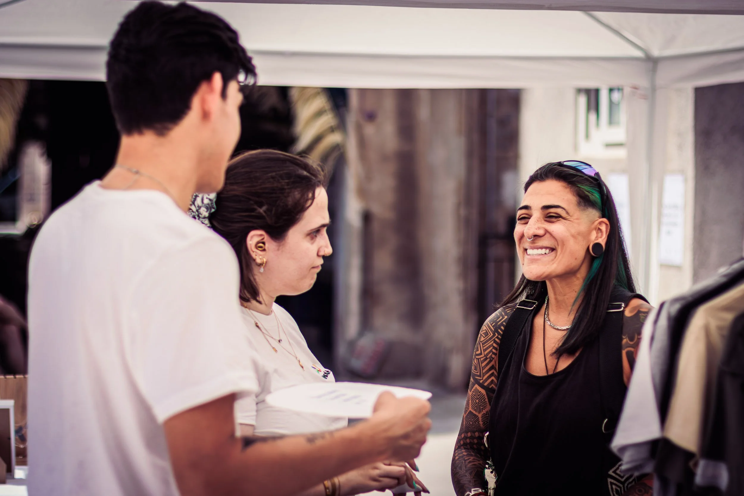 Visitors talking with a vendor at a booth during the event