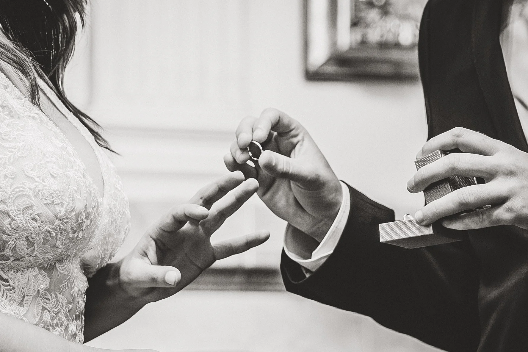 Close-up of the couple exchanging rings during the wedding ceremony