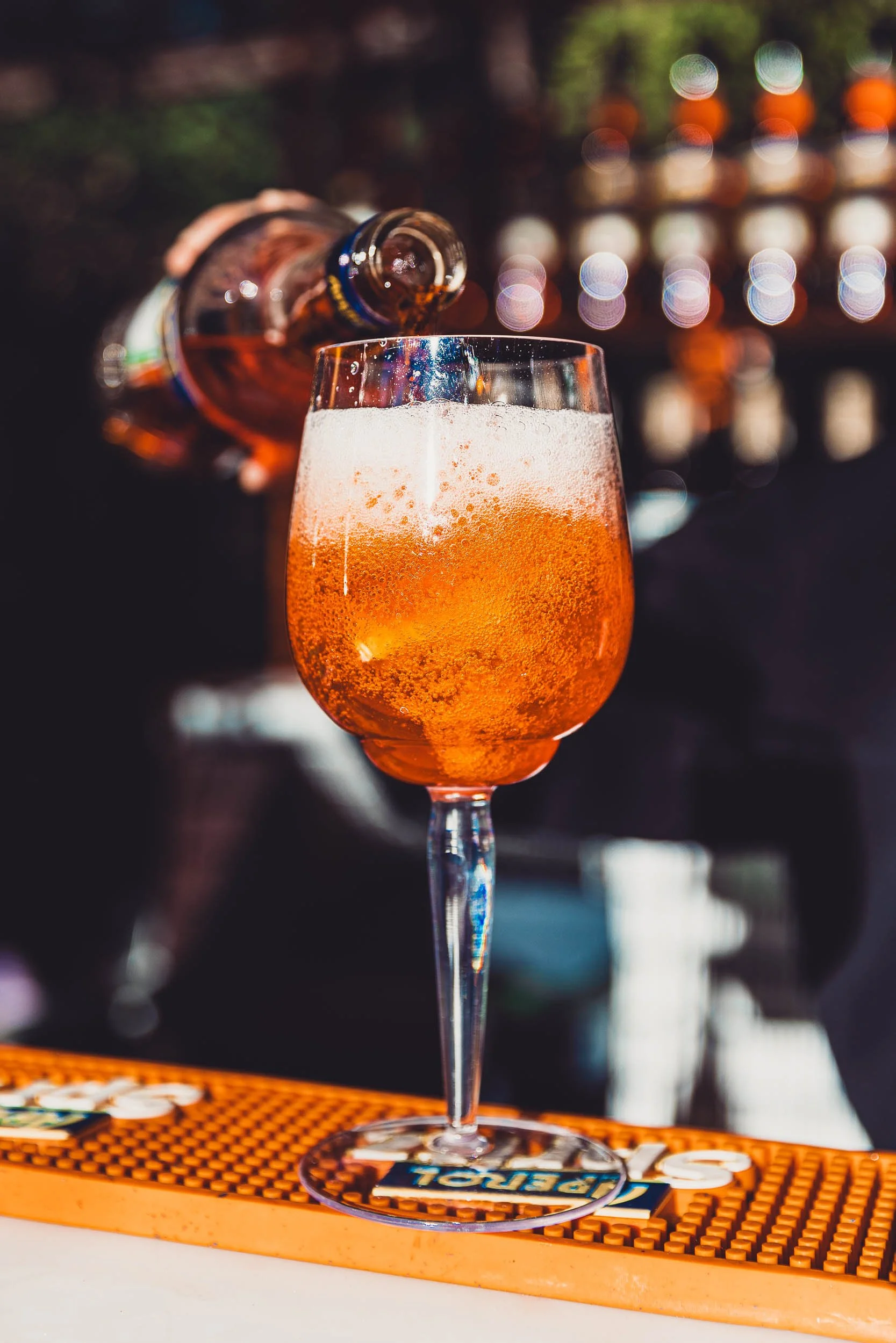 Close-up of an orange cocktail on a bar counter during an event