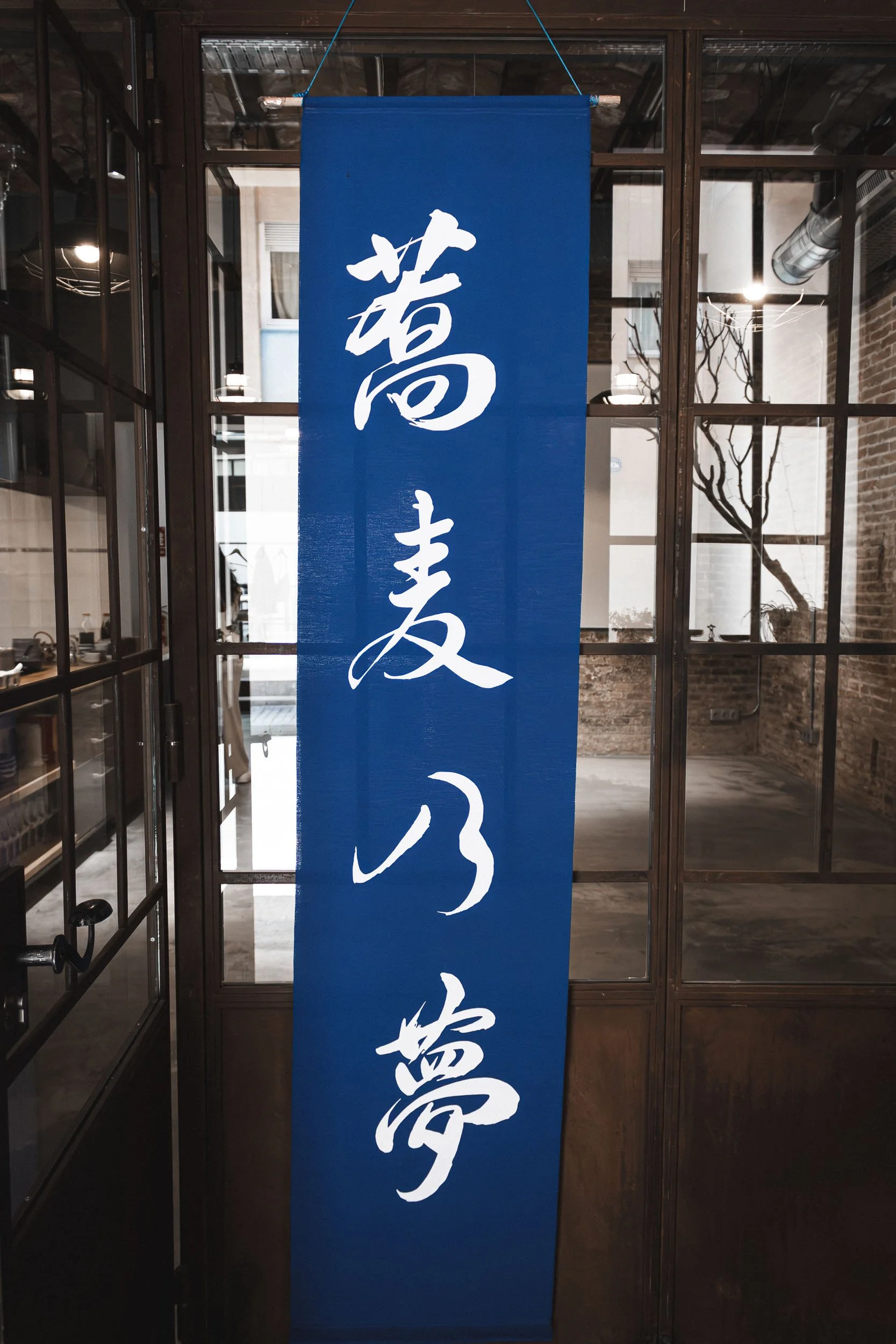 Blue banner with Japanese characters displayed inside a Barcelona restaurant