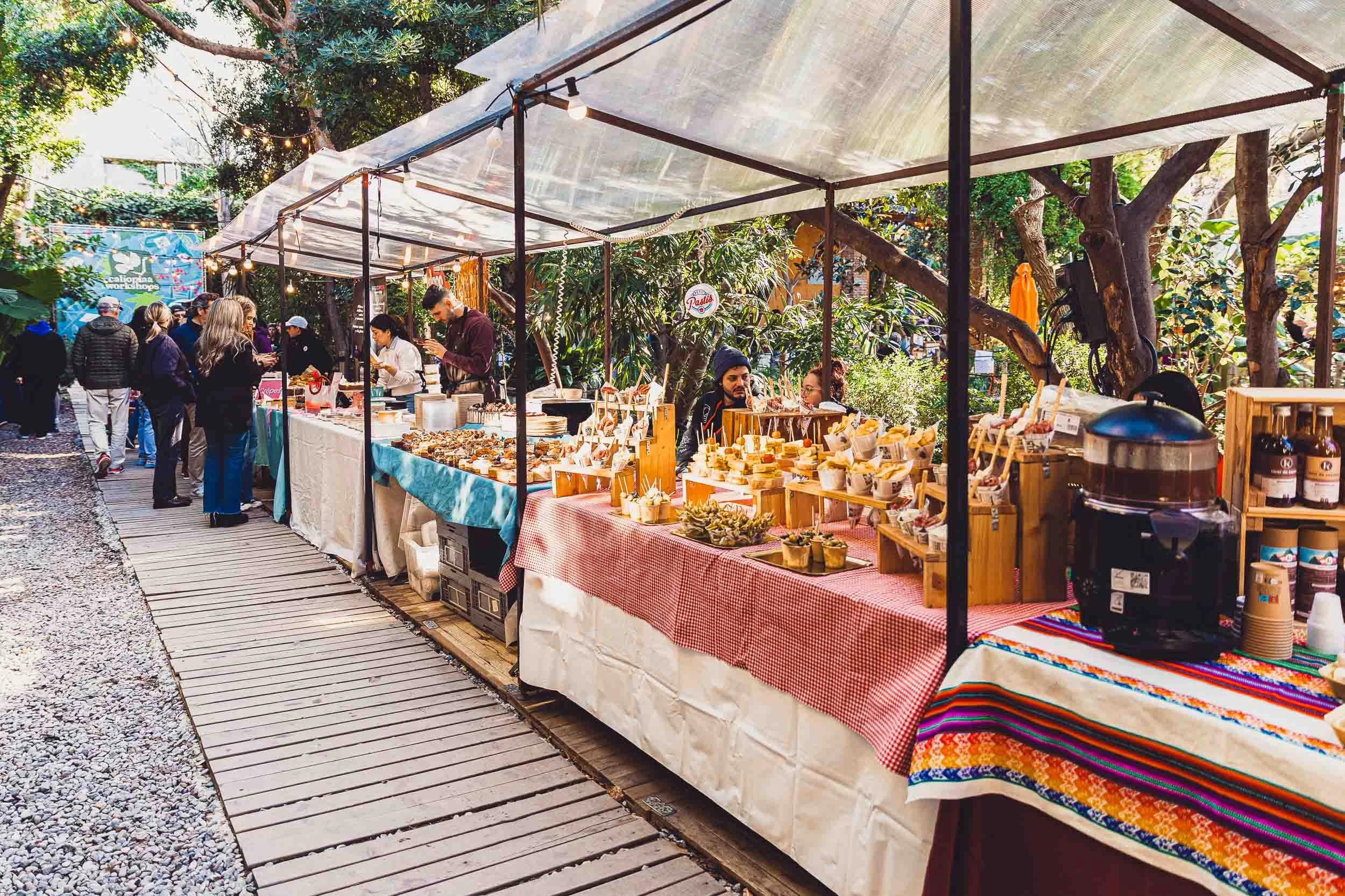 Market stall along a wooden walkway at an outdoor event in Barcelona