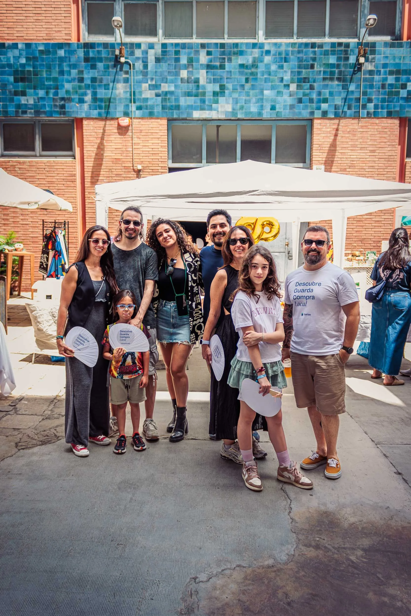Group photo of the organizers in front of a booth at the event