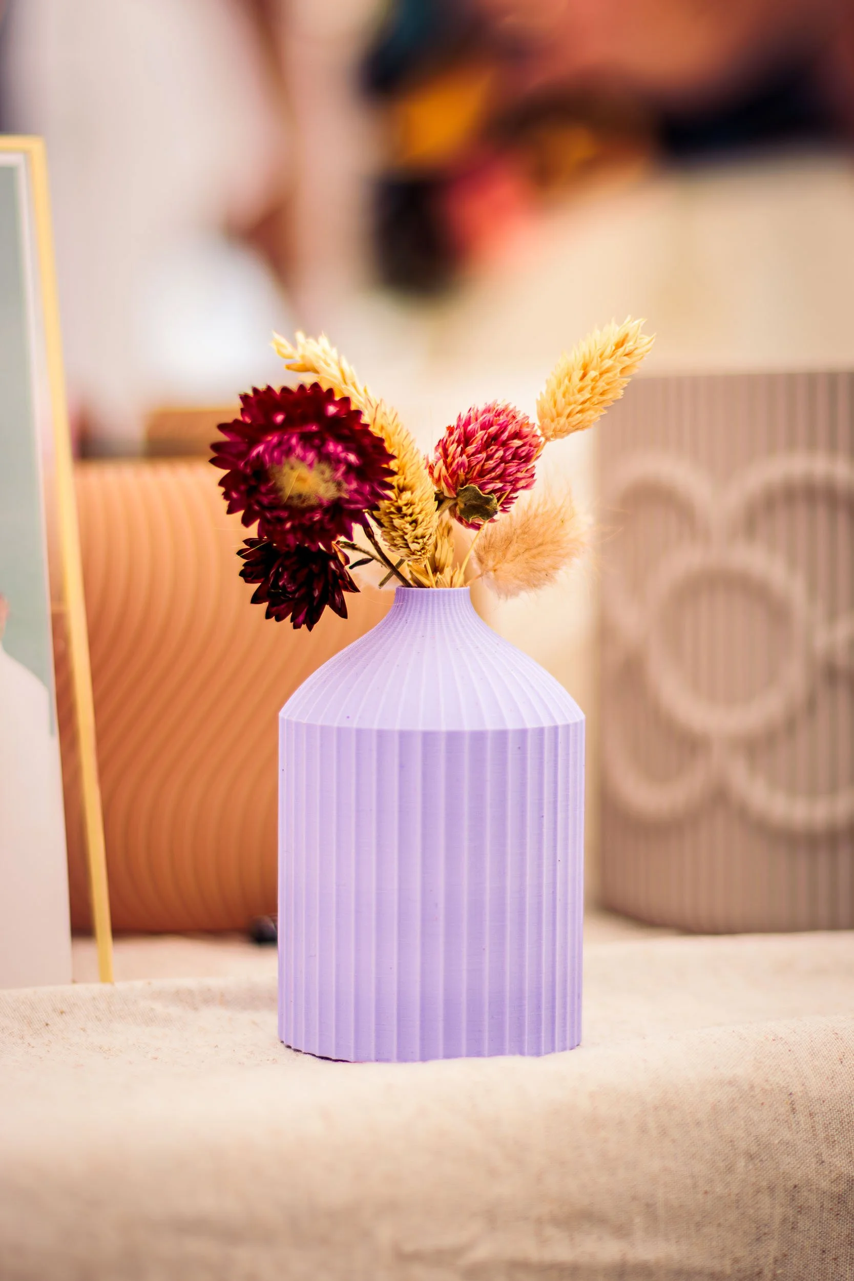 3D printed vase with dried flowers displayed at a brand activation event