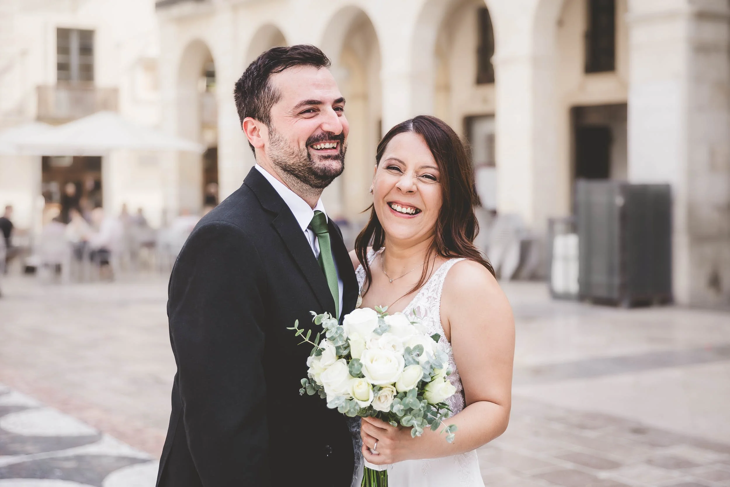 Bride and groom smiling together outdoors after the ceremony.