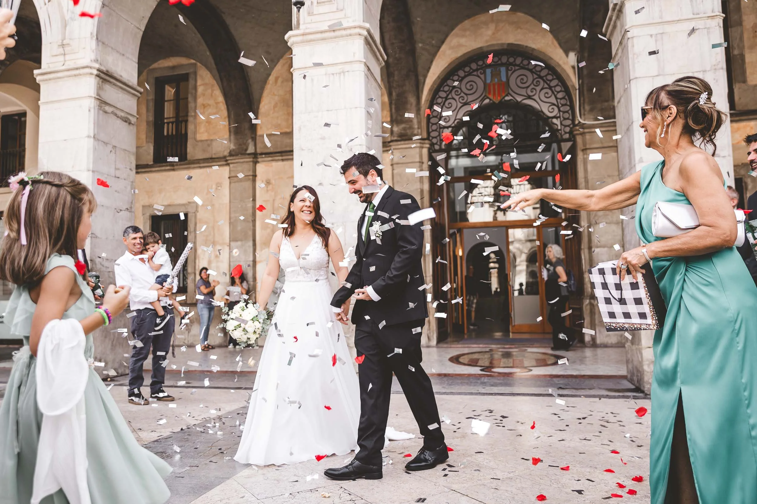 Bride and groom walking out of the ceremony entrance during the confetti exit