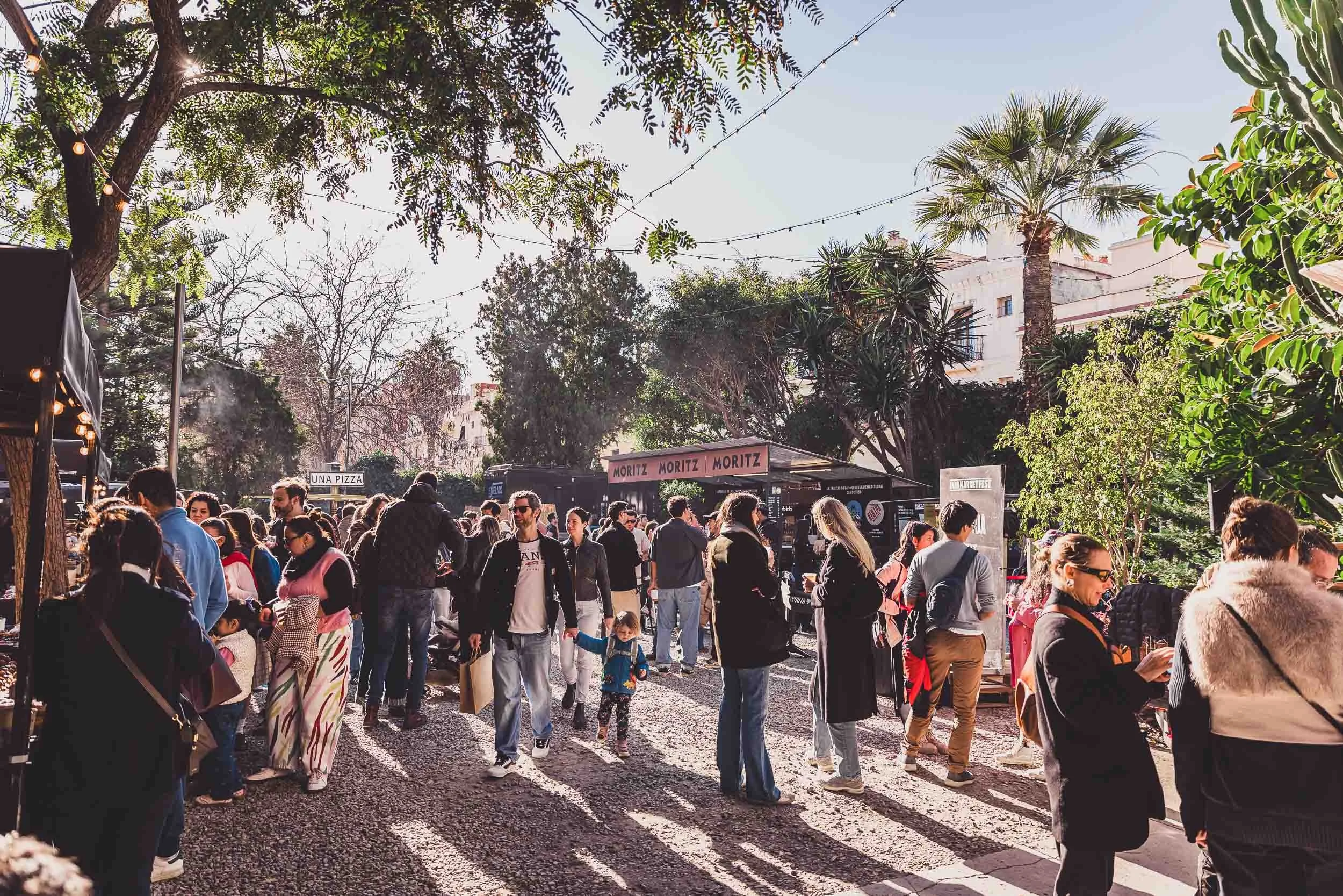 Crowd walking through an outdoor market event in Barcelona
