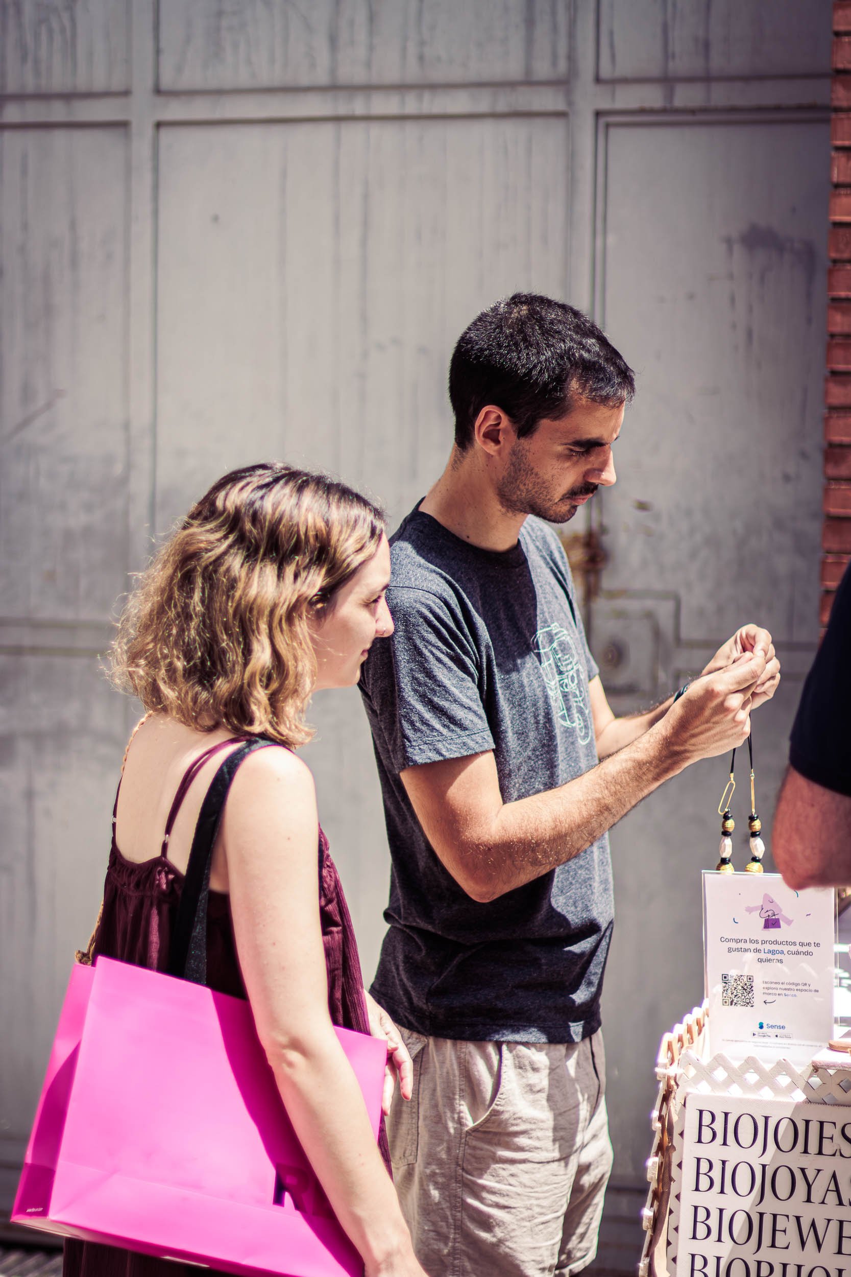 Two visitors browsing products at a stall