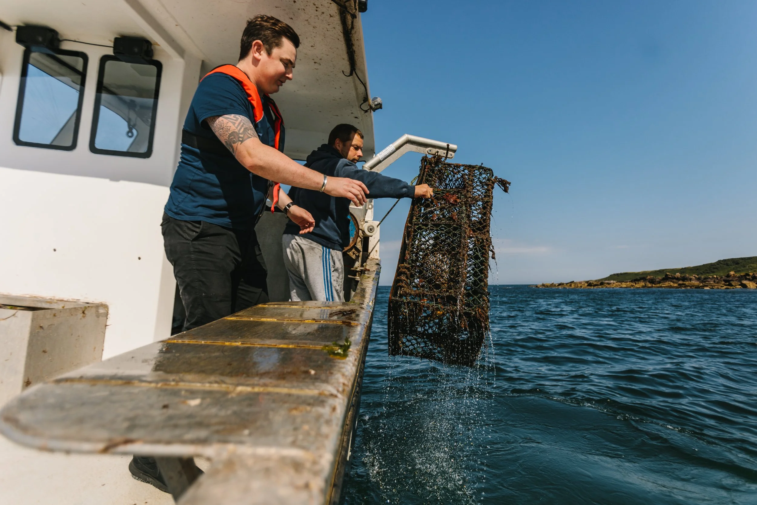 Chef Dean Banks and a fisherman catching lobster with a creel