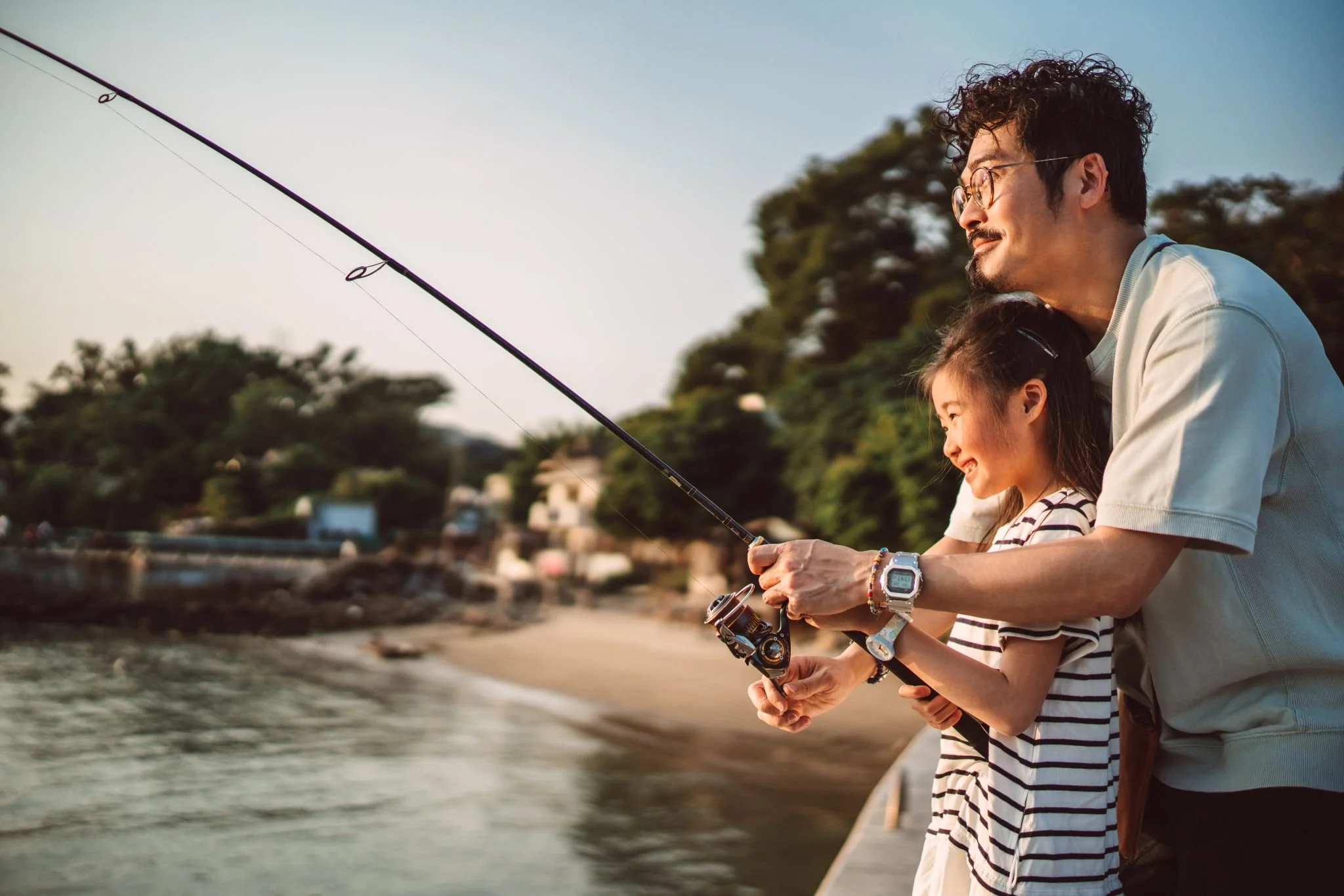 Image of a father and daughter fishing, for the Genius campaign.