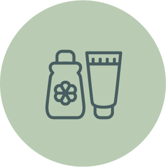 Illustration of a bottle with a flower on it and a tube of cream or lotion, set against a light green circular background.