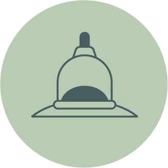 A simple illustration of a dome-shaped object with a small protrusion on top, resembling a cupping technique used in massage therapy.