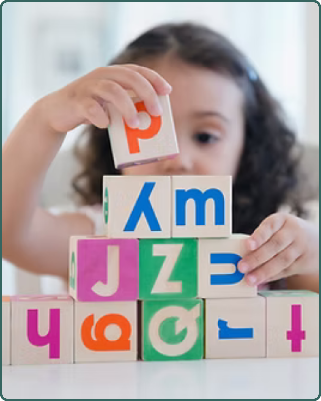 The Therapy Hub Services - Occupational Therapy in Manahawkin, NJ - A little girl stacking blocks