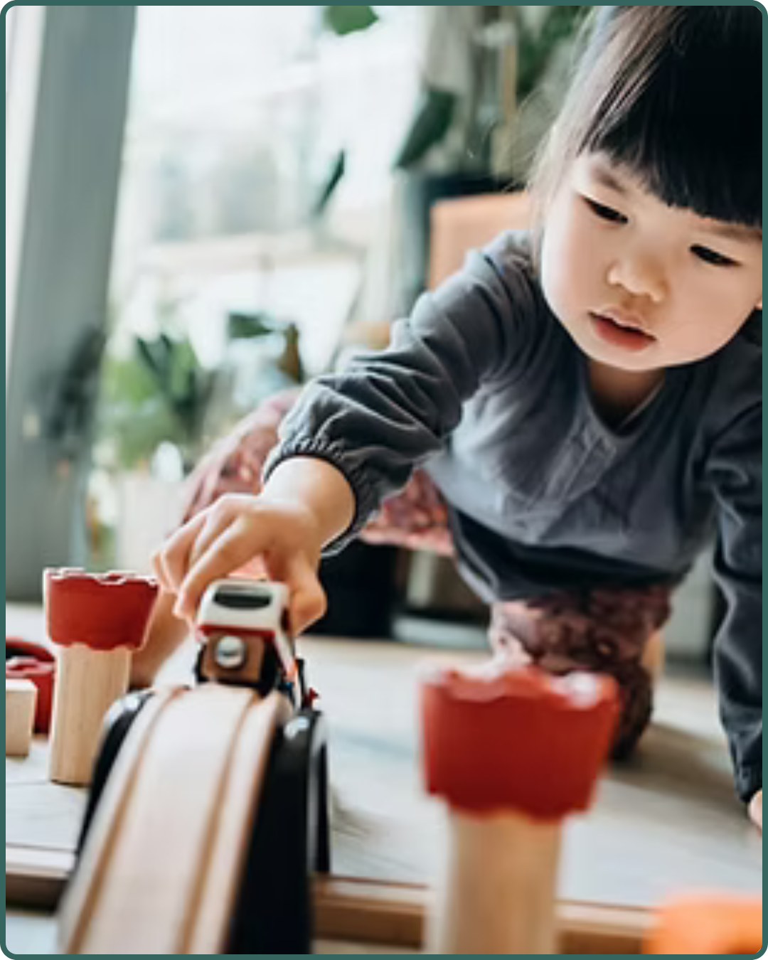 The Therapy Hub - Play Therapy Services in Manahawkin, NJ - A little girl playing with wood toys