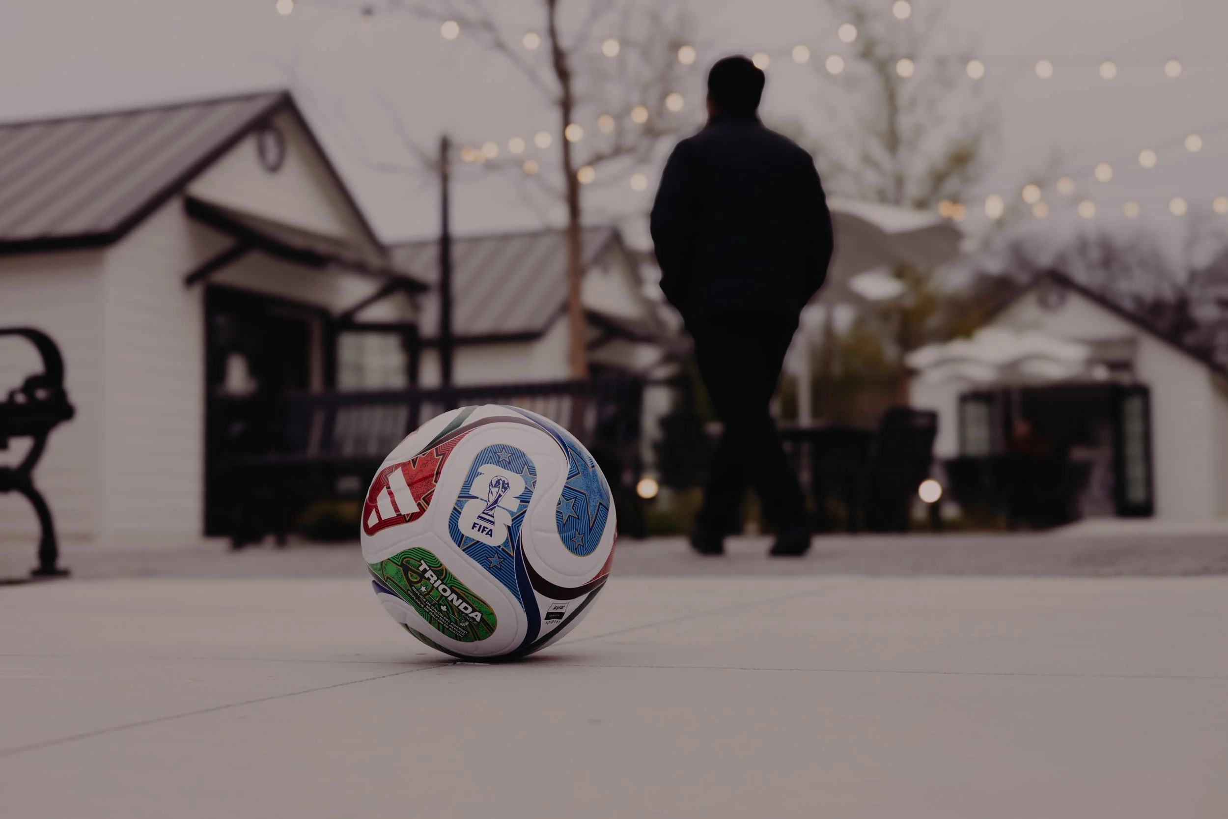 Trionda soccer ball with twinkle lights above cottage market shops