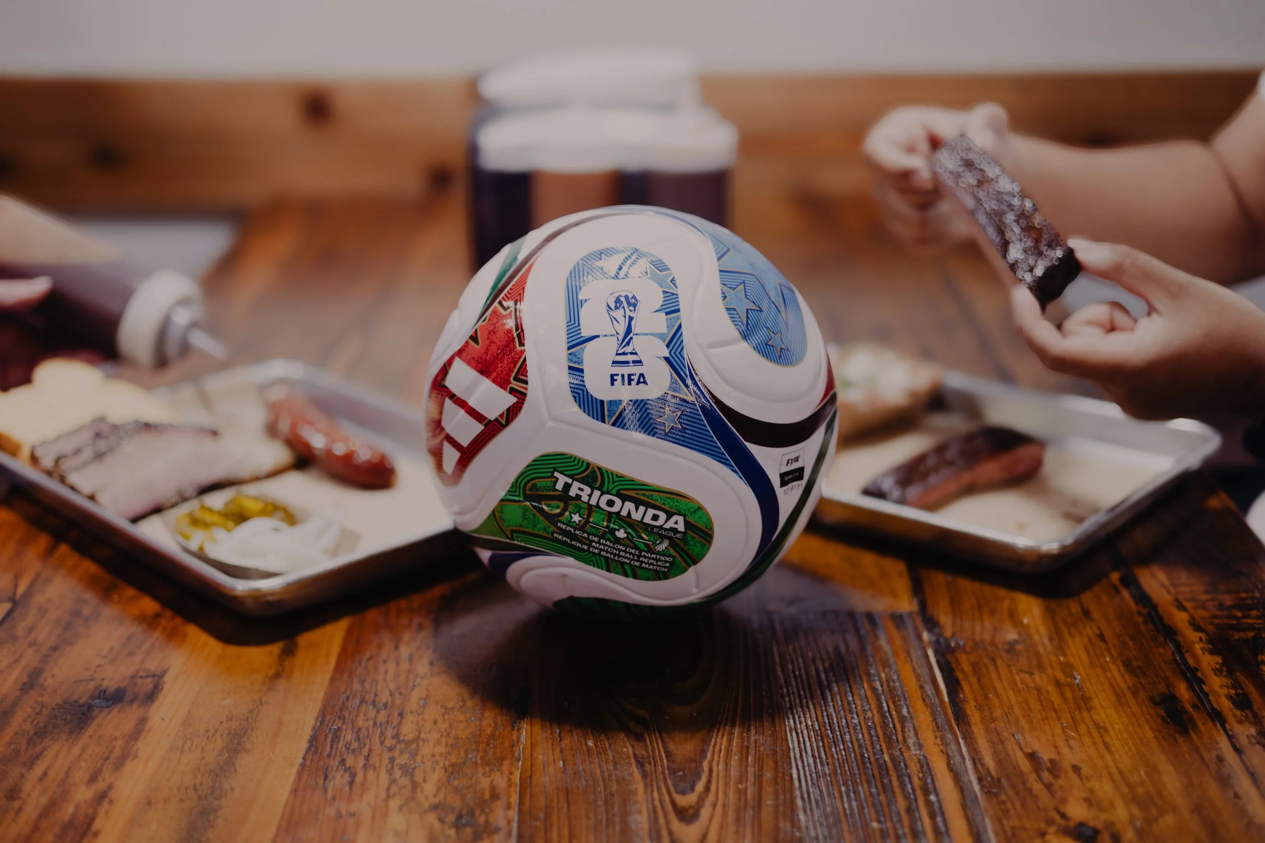 Trionda soccer ball on table with barbecue