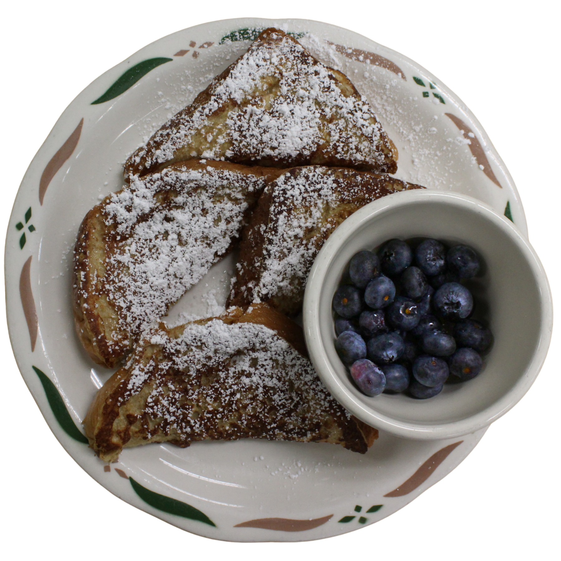 Plate with four French toast slices dusted with powdered sugar and a side bowl of blueberries at Sweet-T-Cafe in West Jefferson, NC.