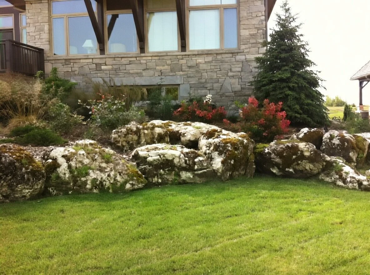 mossy limestone boulder retaining wall nestling the house in