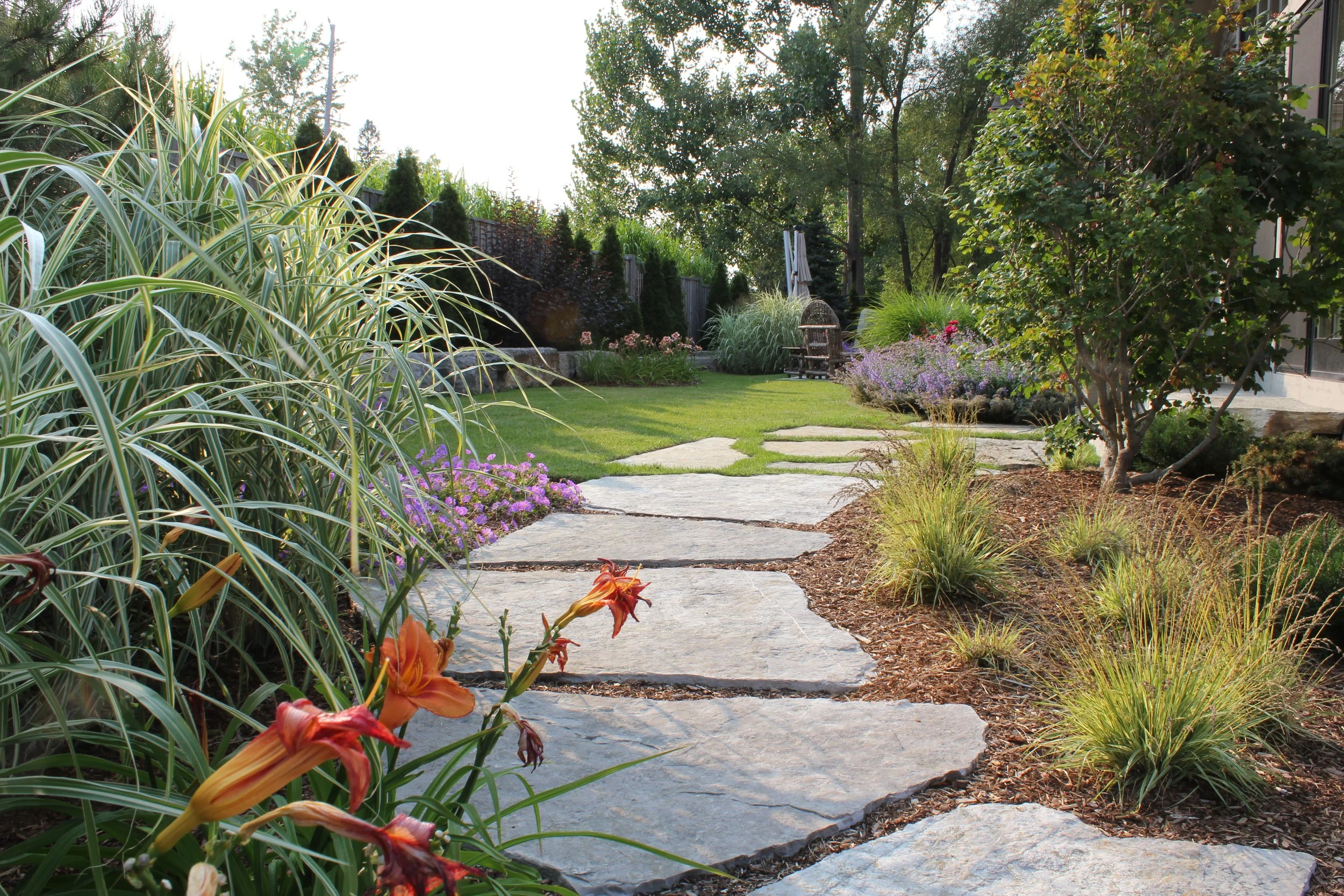 natural stone pathway leading through the garden