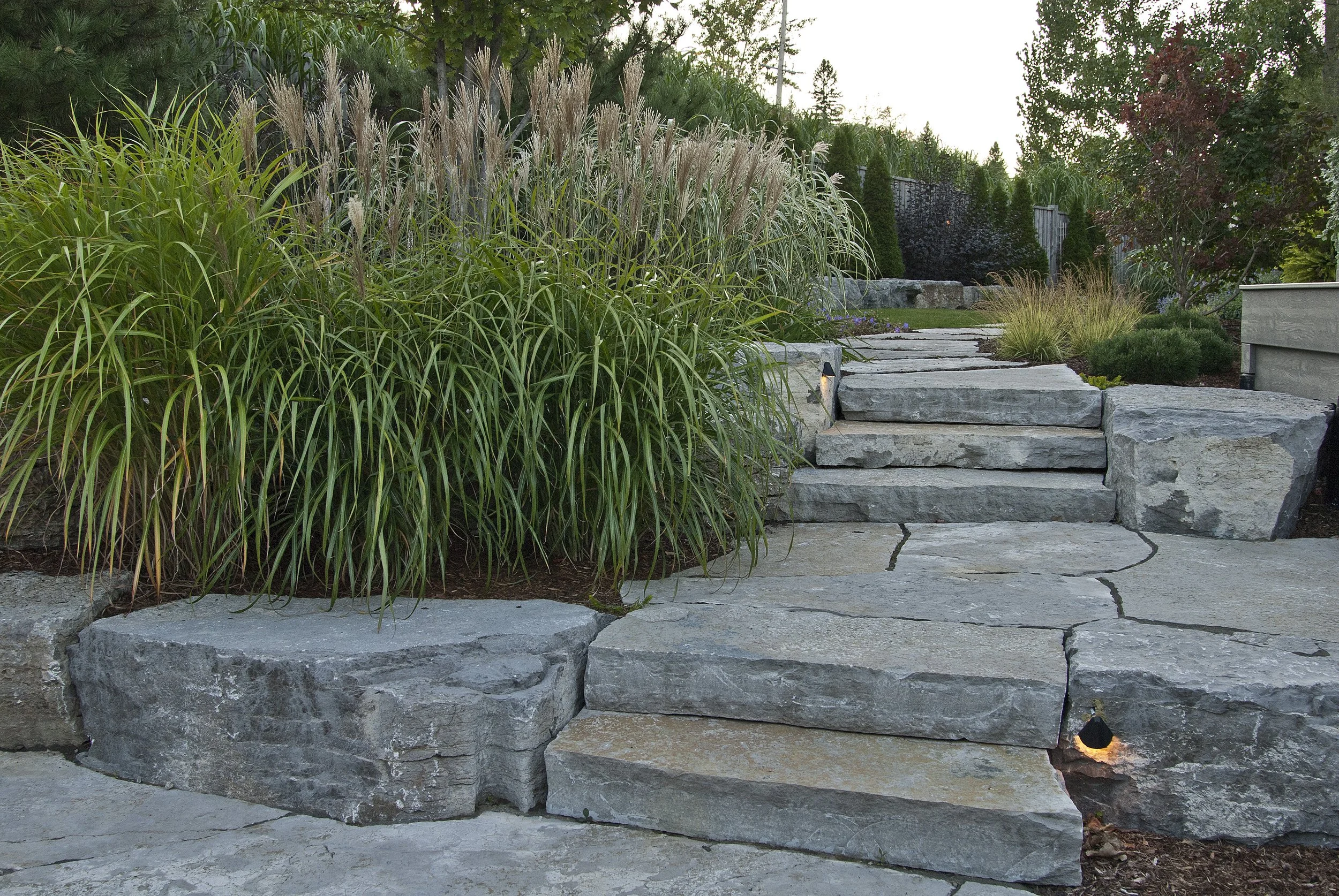 Natural stone trifecta; flagstone patio, stone steps and armourstone retaining