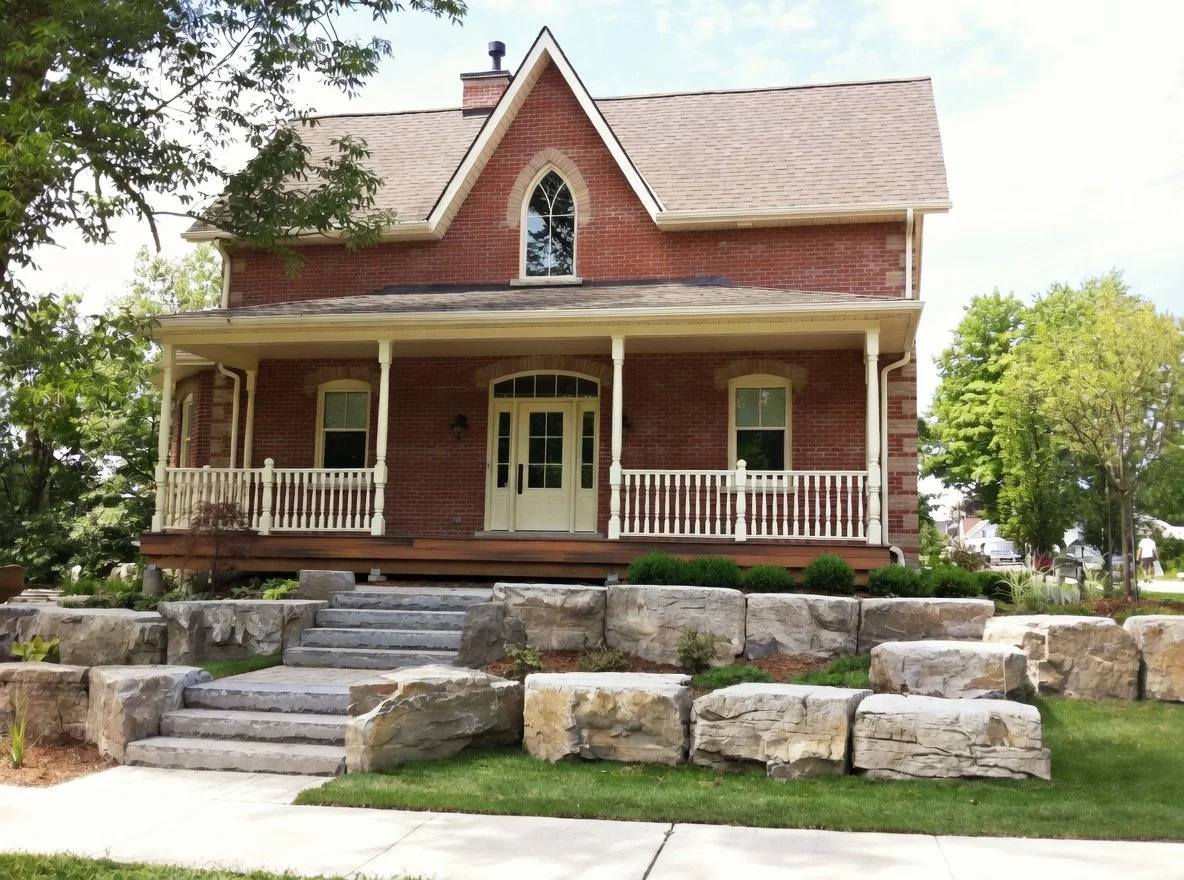 Square cut limestone steps with armourstone to help nestle the house in