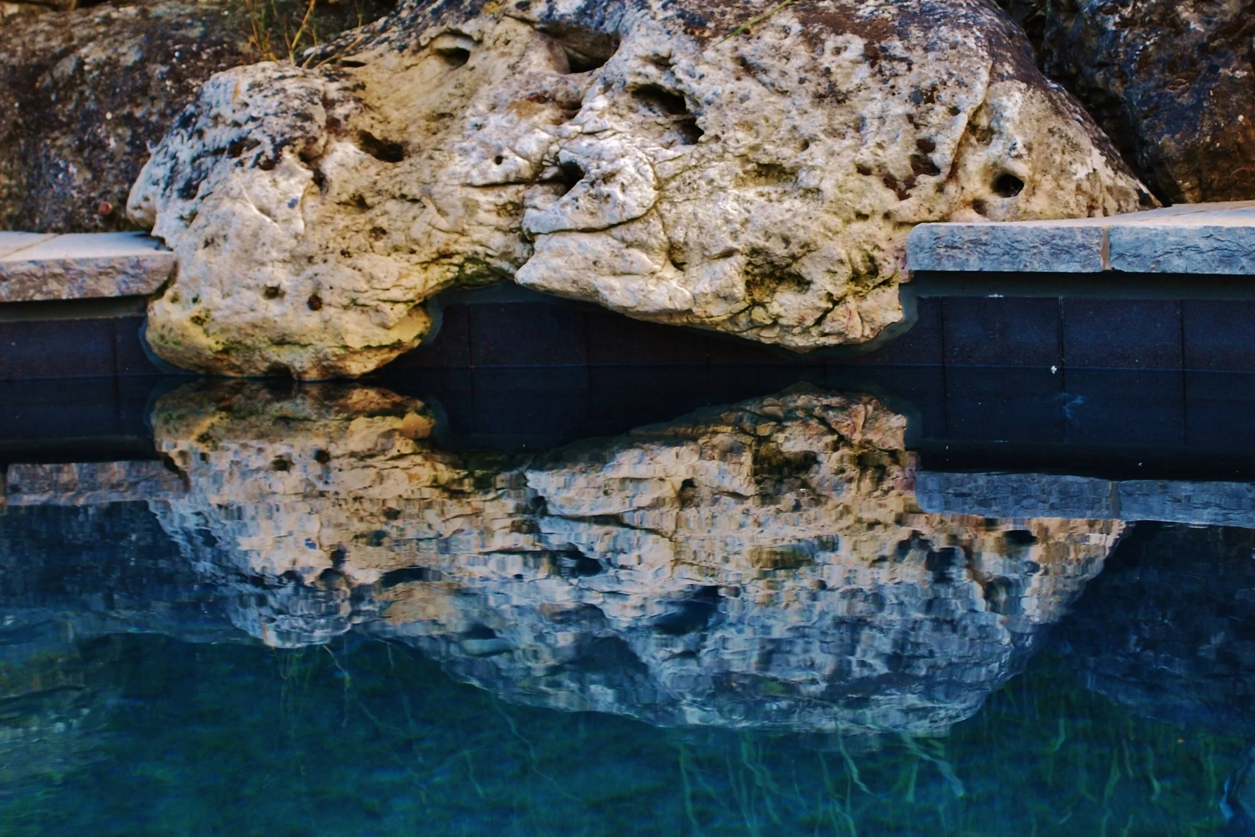 Weathered limestone dipping its toes in the water