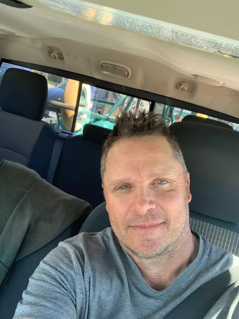 Jamie, owner of the lawn care company, in his car and ready to provide professional lawn and landscape services.