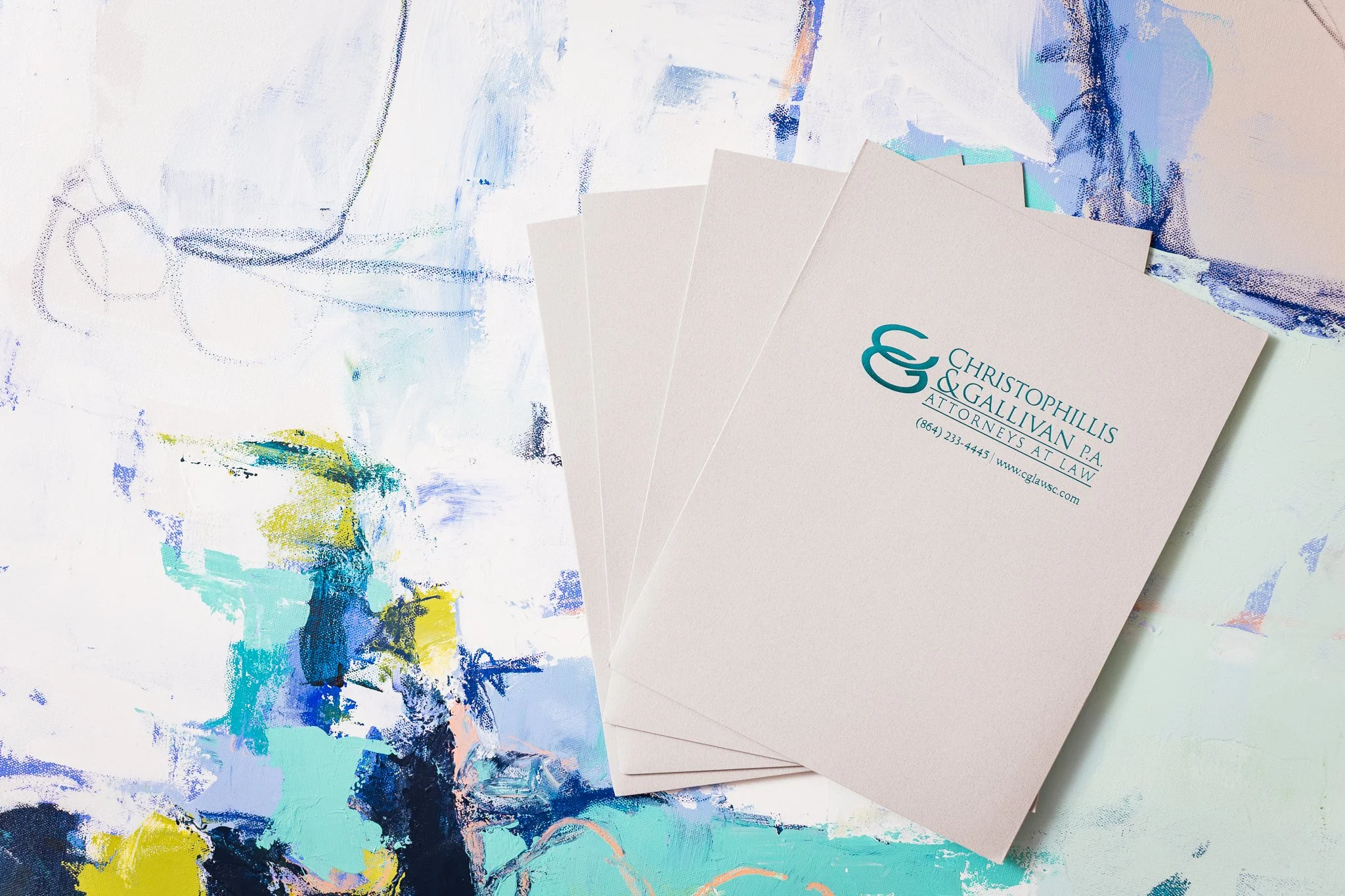 Business cards for Christophullis & Gallivan P.A. law firm on an abstract colorful background.