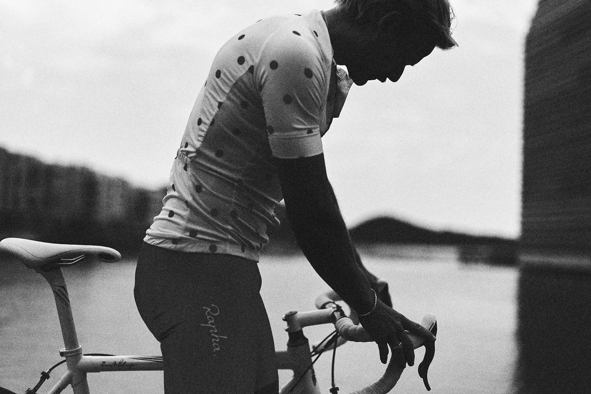 Black and white portrait of a cyclist with his bike, lifestyle photography by Oivind Haug