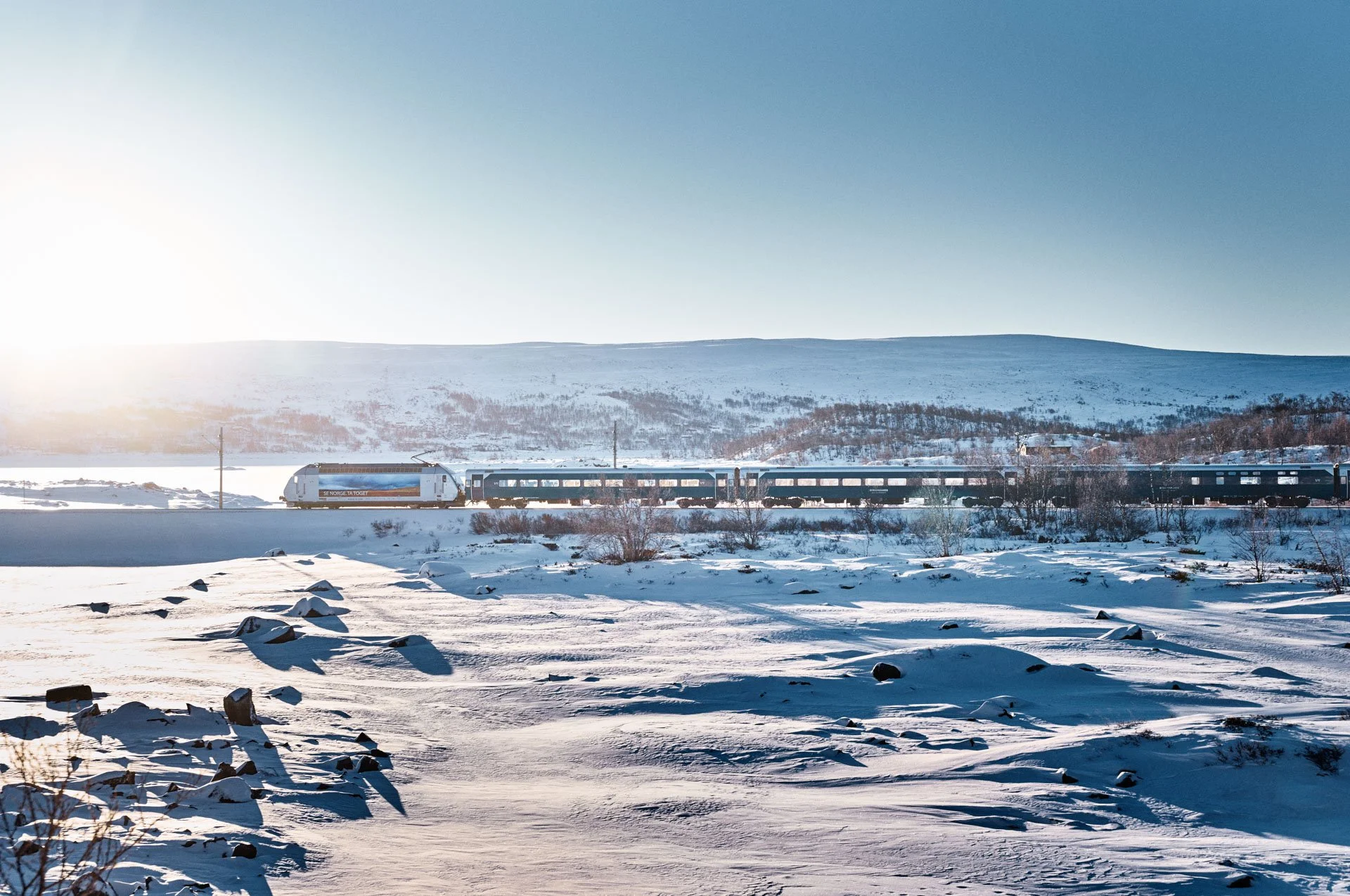Vy train in winter landscape near Finse, Bergen Line, Norway
