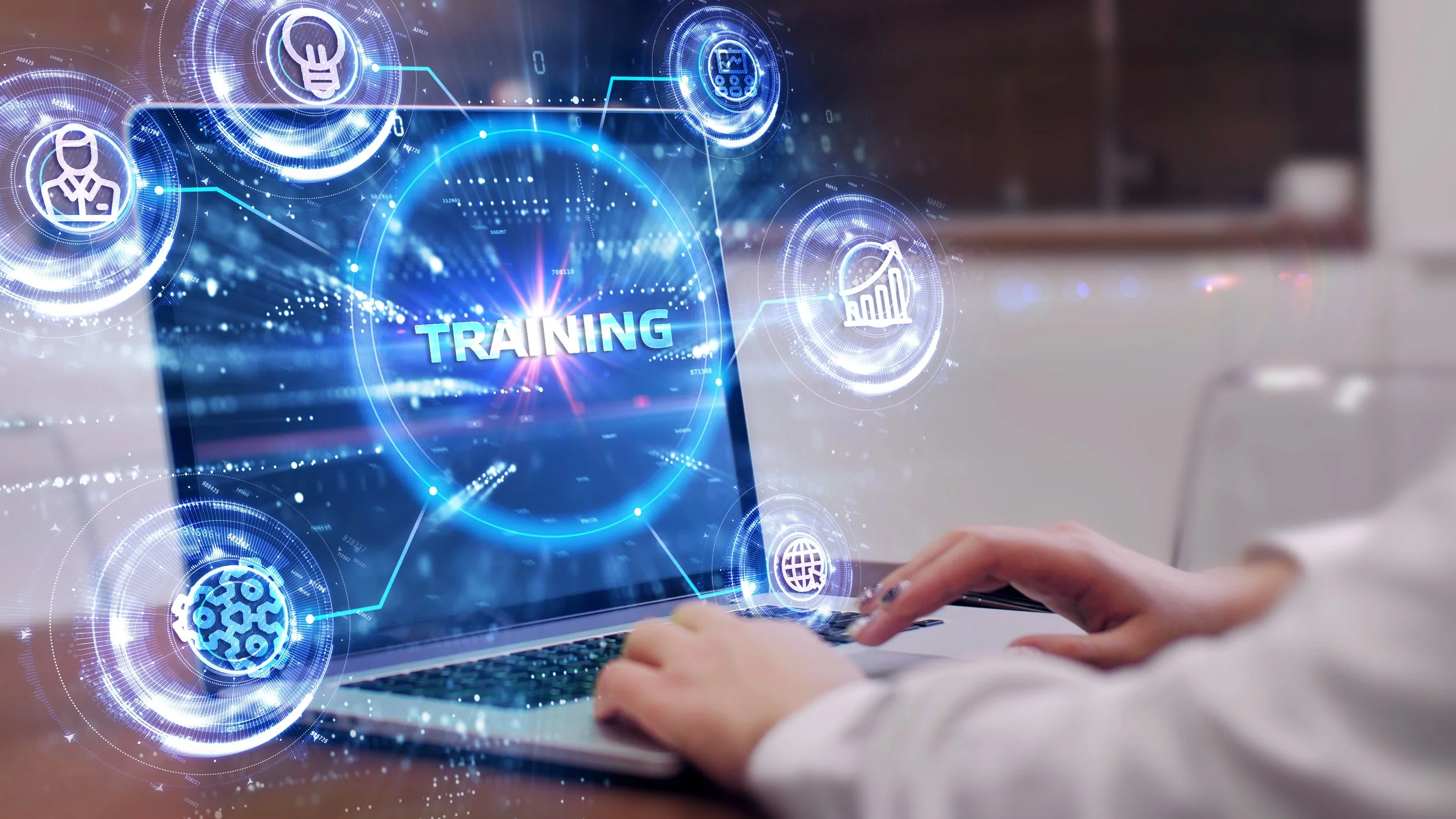 Laptop screen with the text training on it with bubbles on the outside