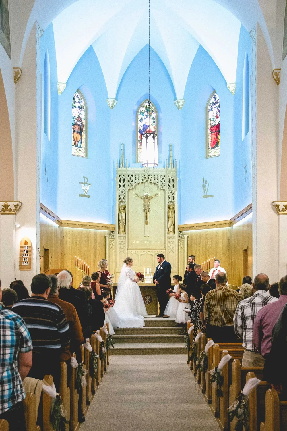 Wedding ceremony inside a church with high arched ceilings