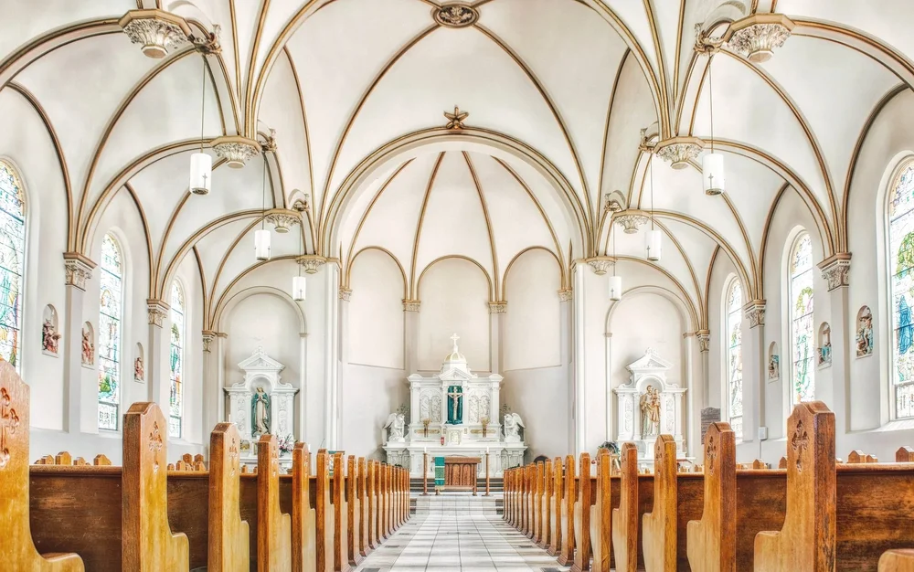 Church interior with wooden pews and stained glass