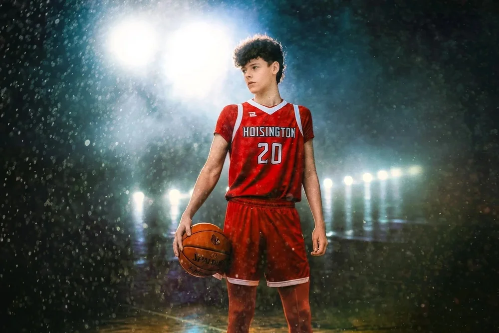 Senior athlete with a basketball under dramatic stadium lights